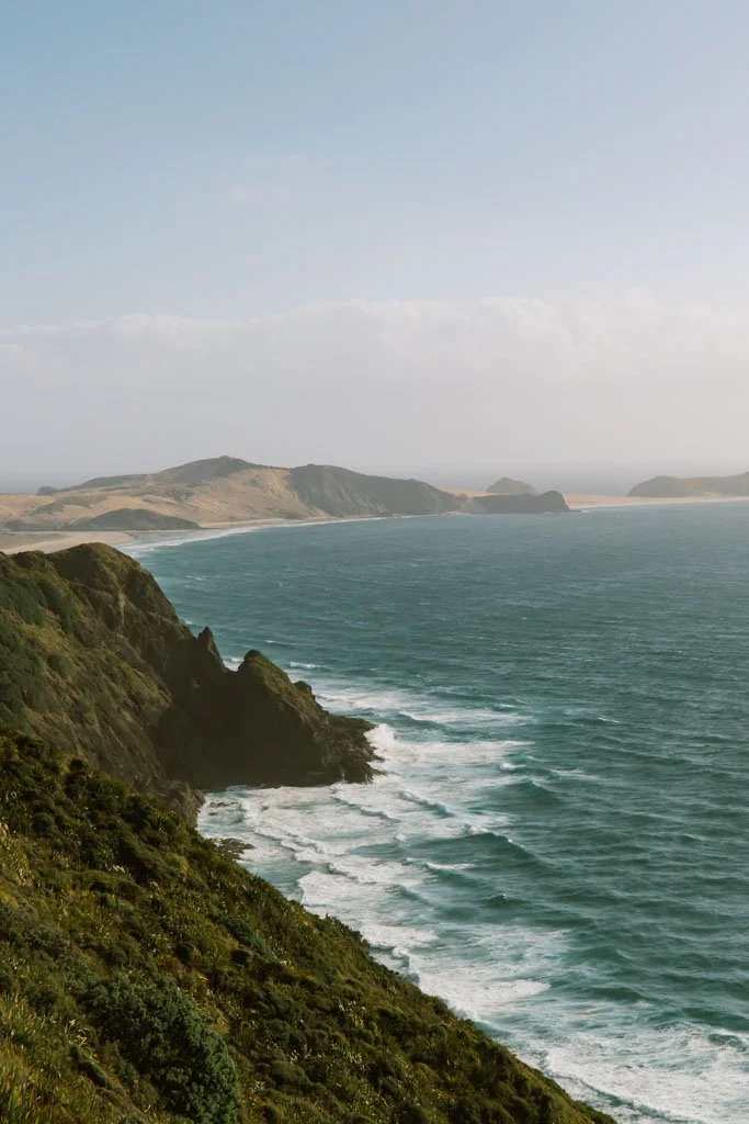 Rugged waves crash against steep cliffs at Cape Reinga