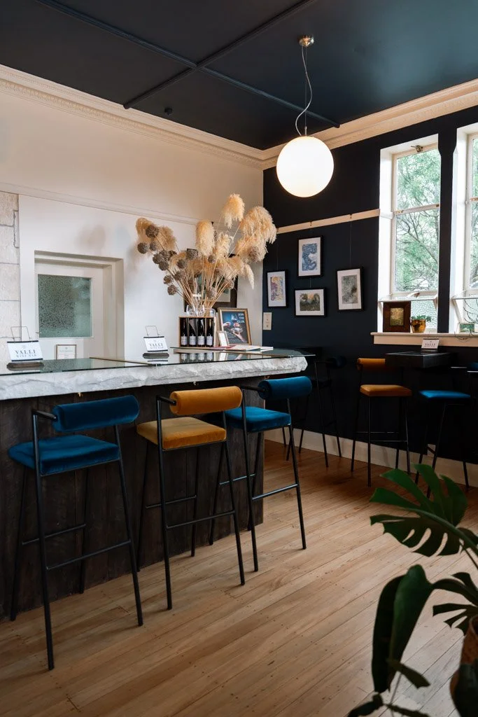 Valli wine bar in Kurow with a marble counter top and chairs with yellow and deep blue velvet