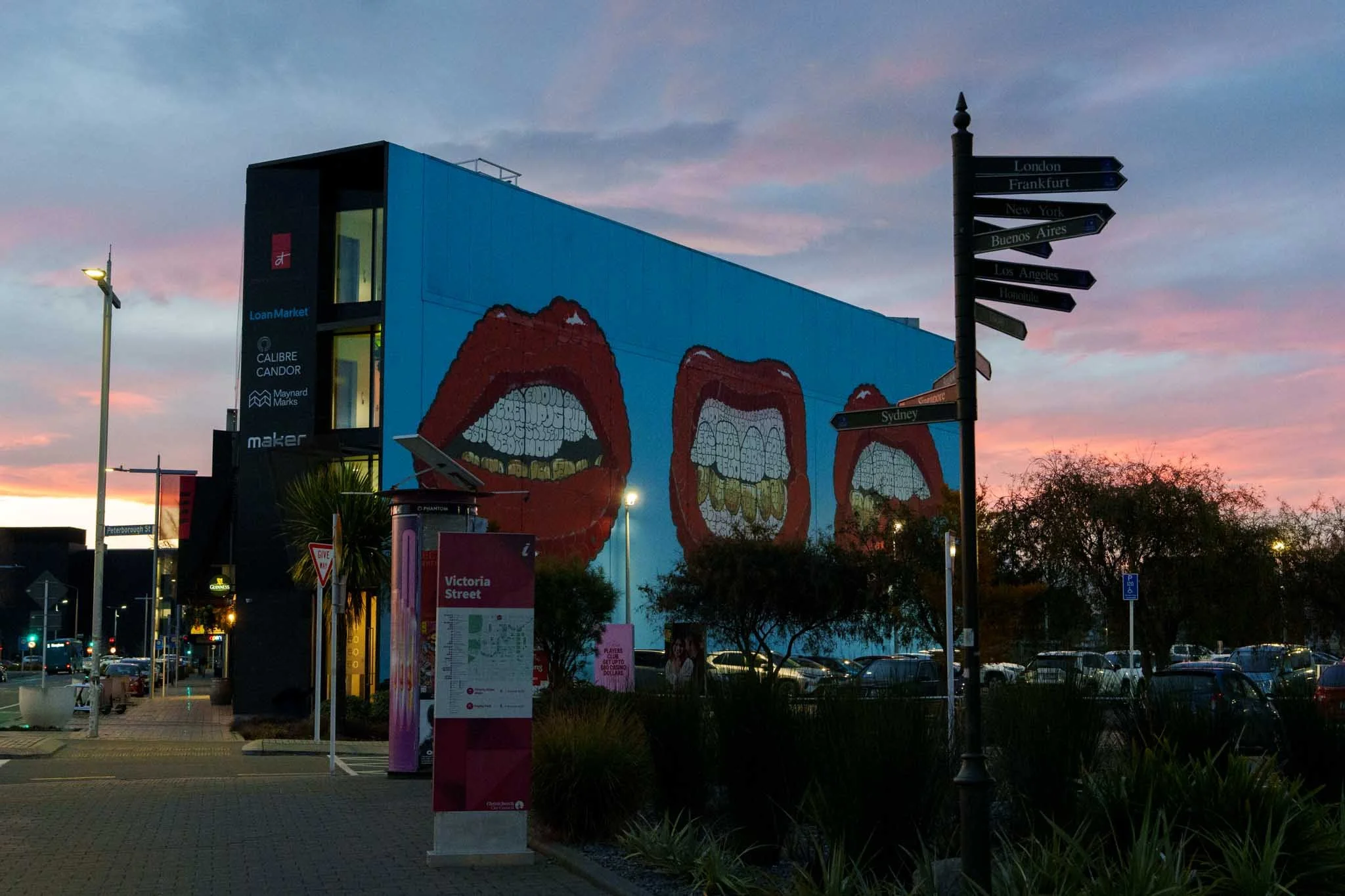 A wall in Christchurch is painted with a large mural of three mouths
