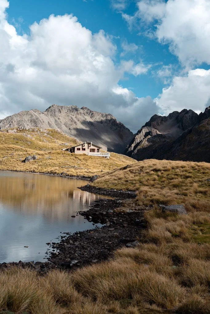 Angelus Hut in Nelson Lakes National Park sits above a calm lake