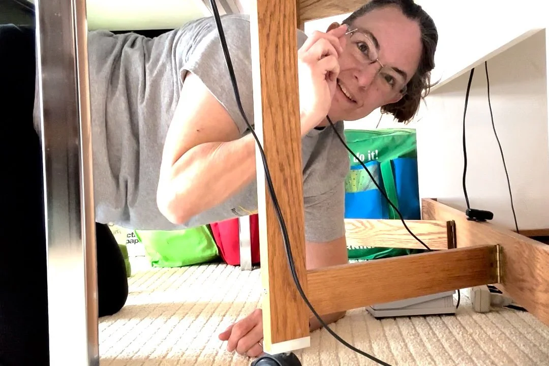 Woman crawls under table to find a dropped sewing needle