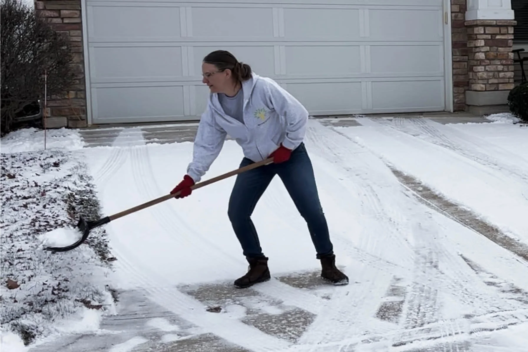 Katherine shovels snow with her left side