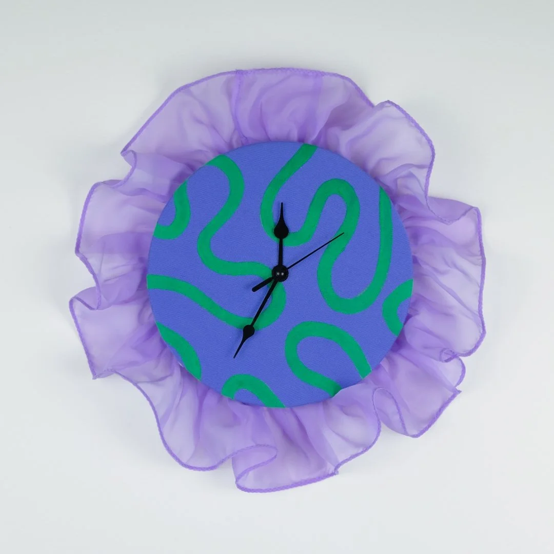 A glow-up of a thrifted clock, complete with hand-painted fabric and, of course, ruffles!

I love thinking about clocks and the concept of time &mdash; our most valuable commodity, yet impossible to make more of. Plus, clocks and their mechanisms are