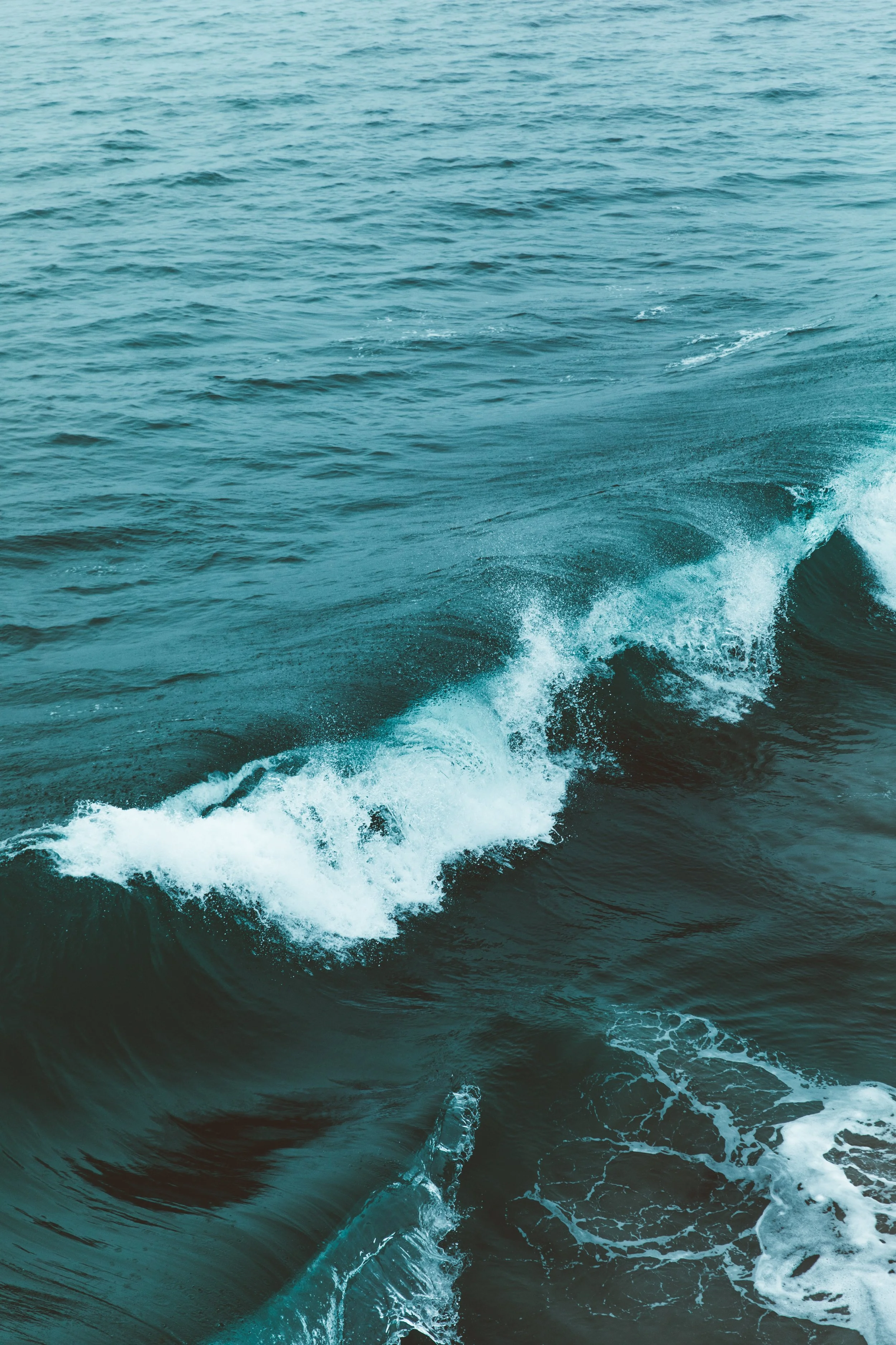 Ocean waves crashing in the sea with foam and spray.