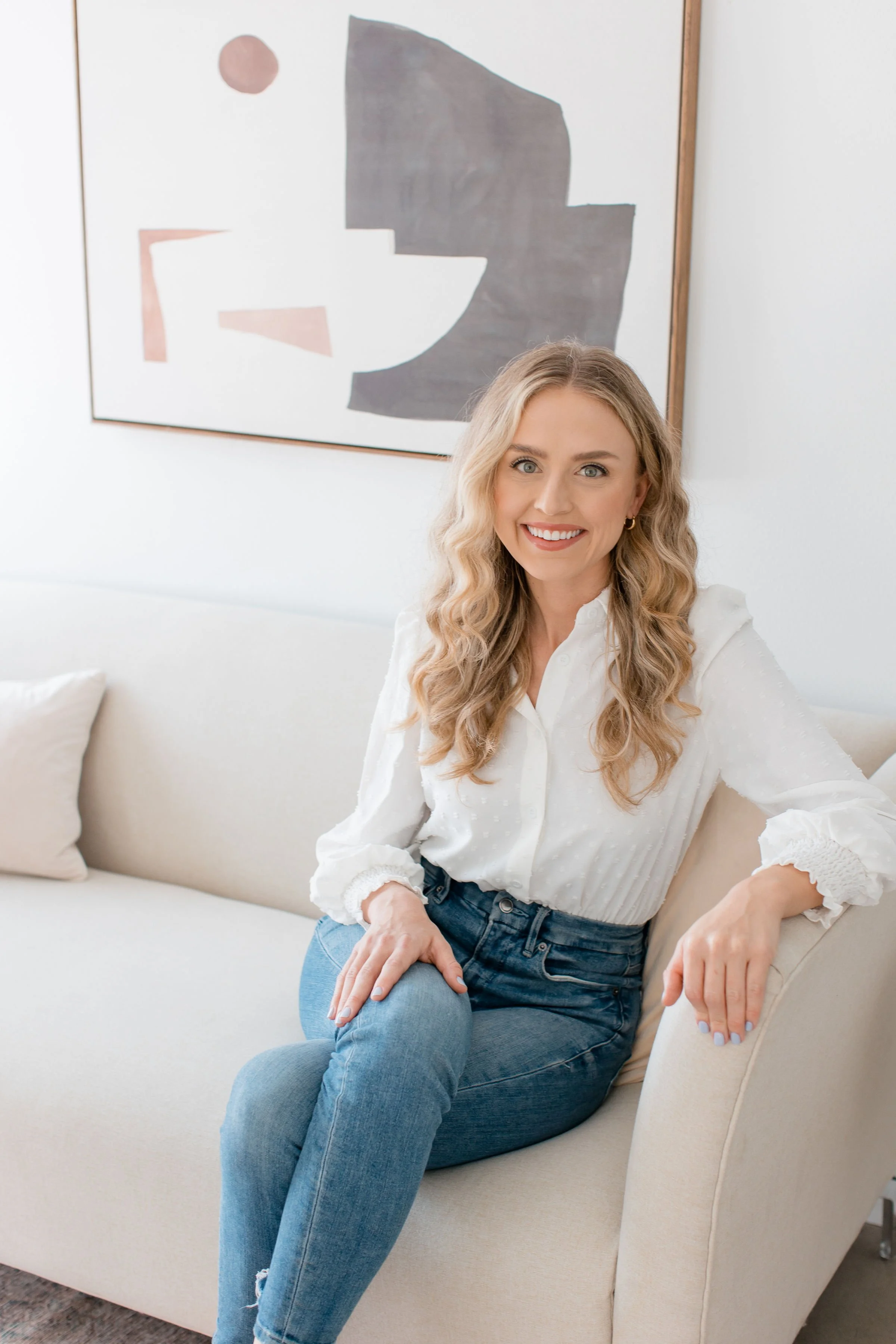 Brooke Sundin, LMFT, sitting on the couch of her therapy office in West Los Angeles