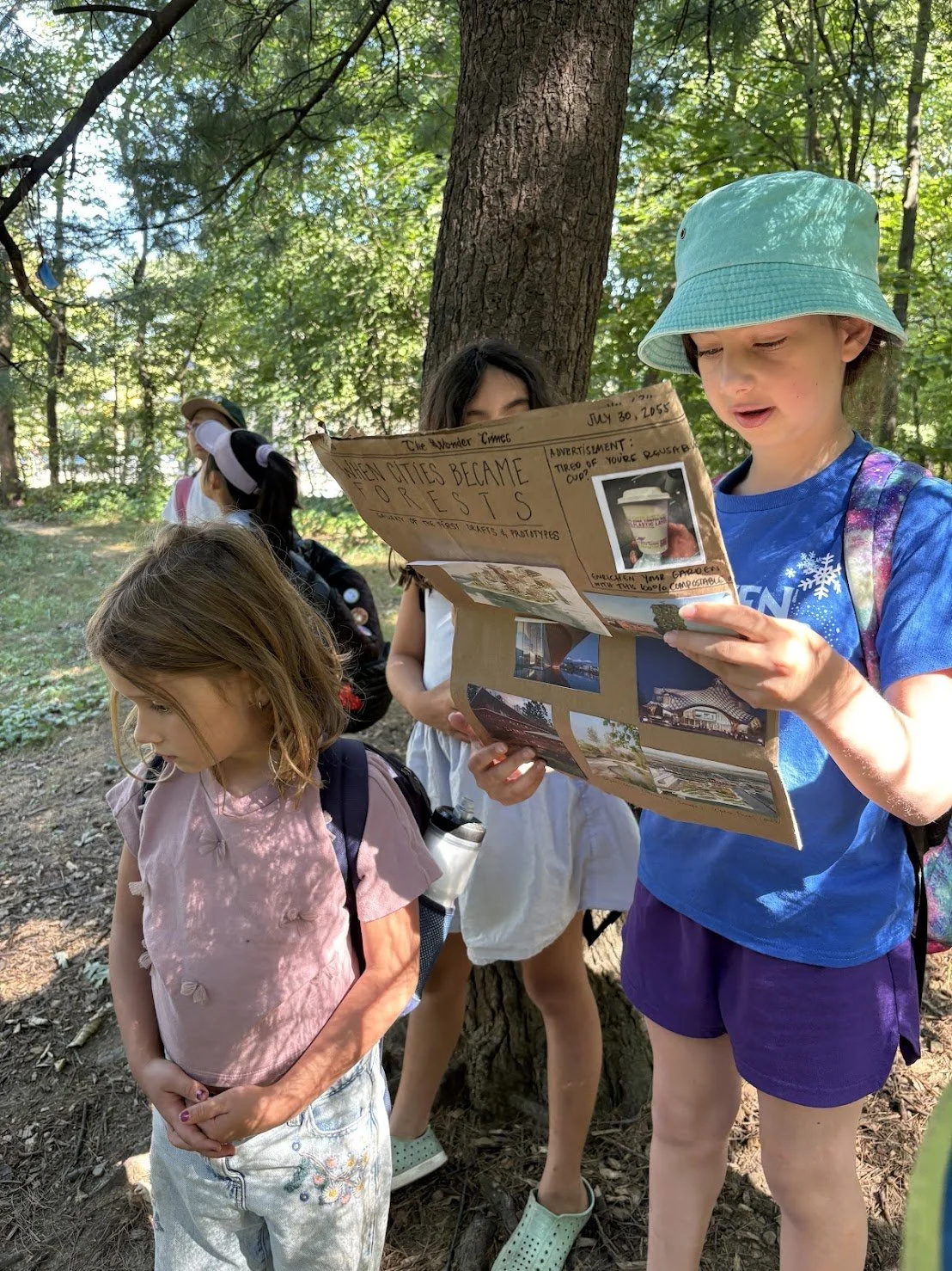 kids reading paper.JPG
