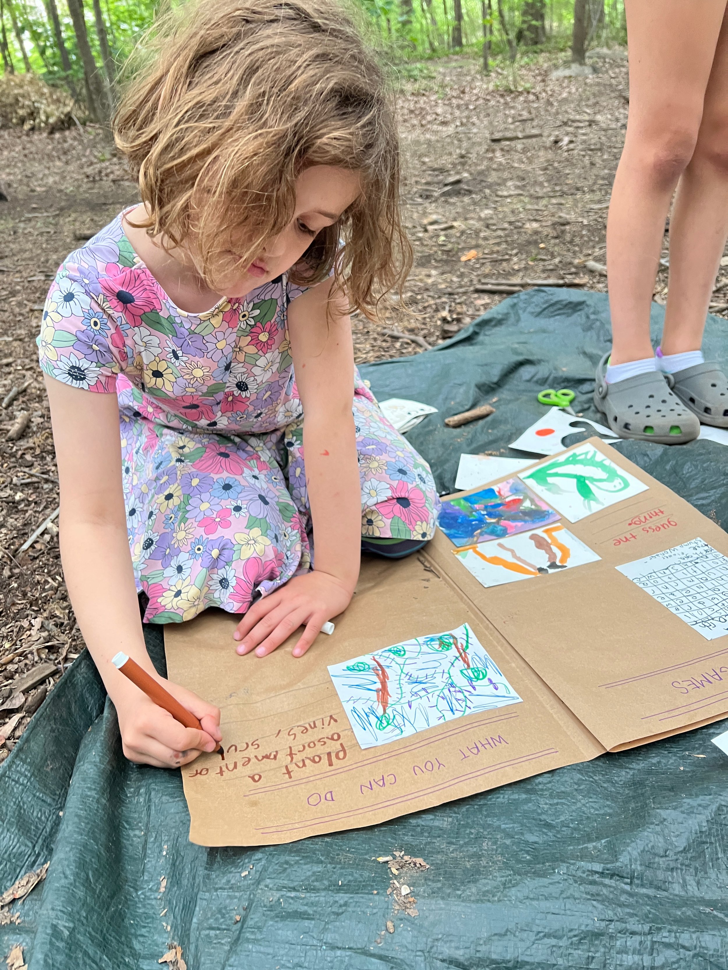 Wonder kids works newspaper activity during after school in Prospect Park