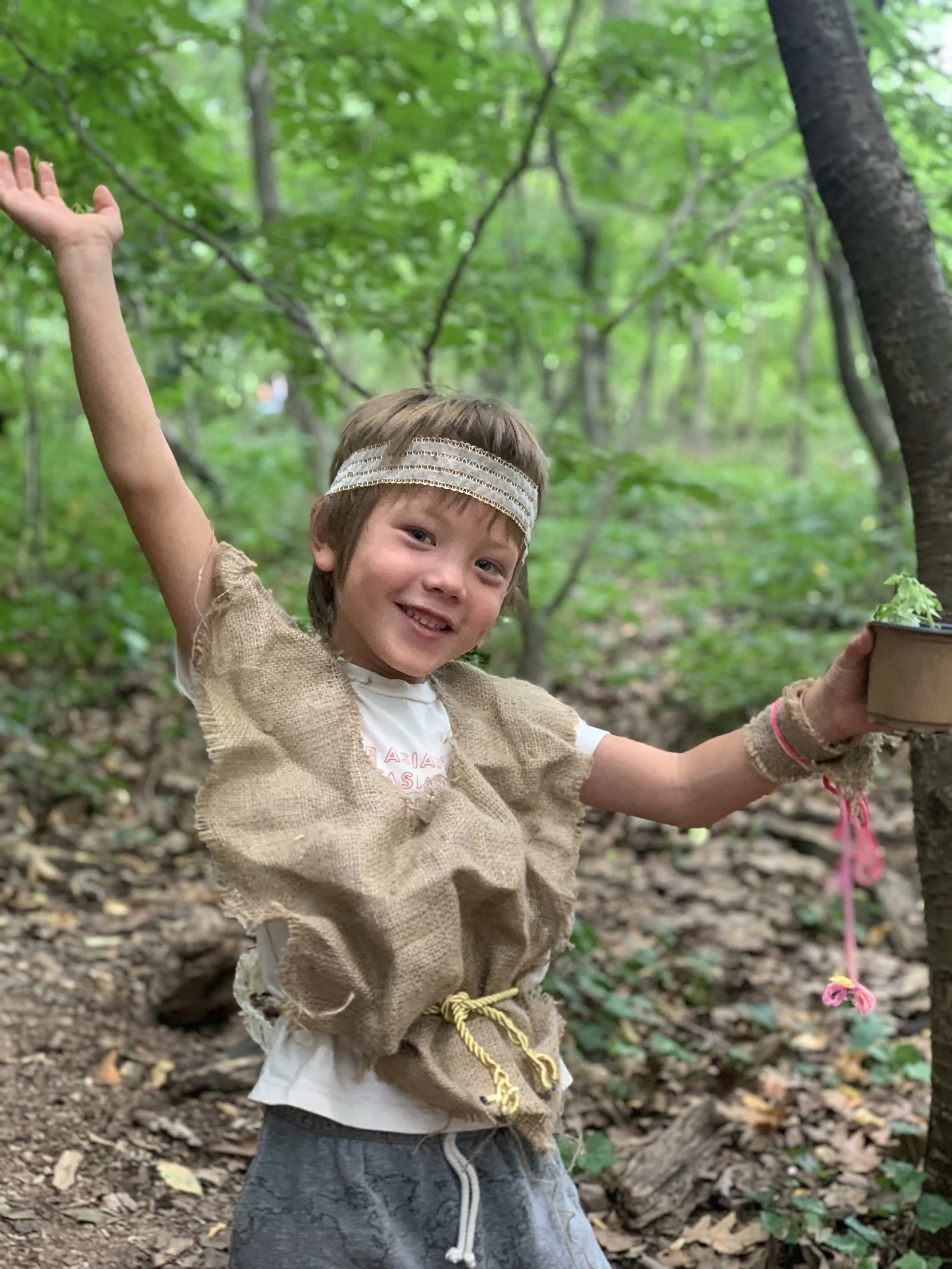Wonder Kid wearing a costume in the woods