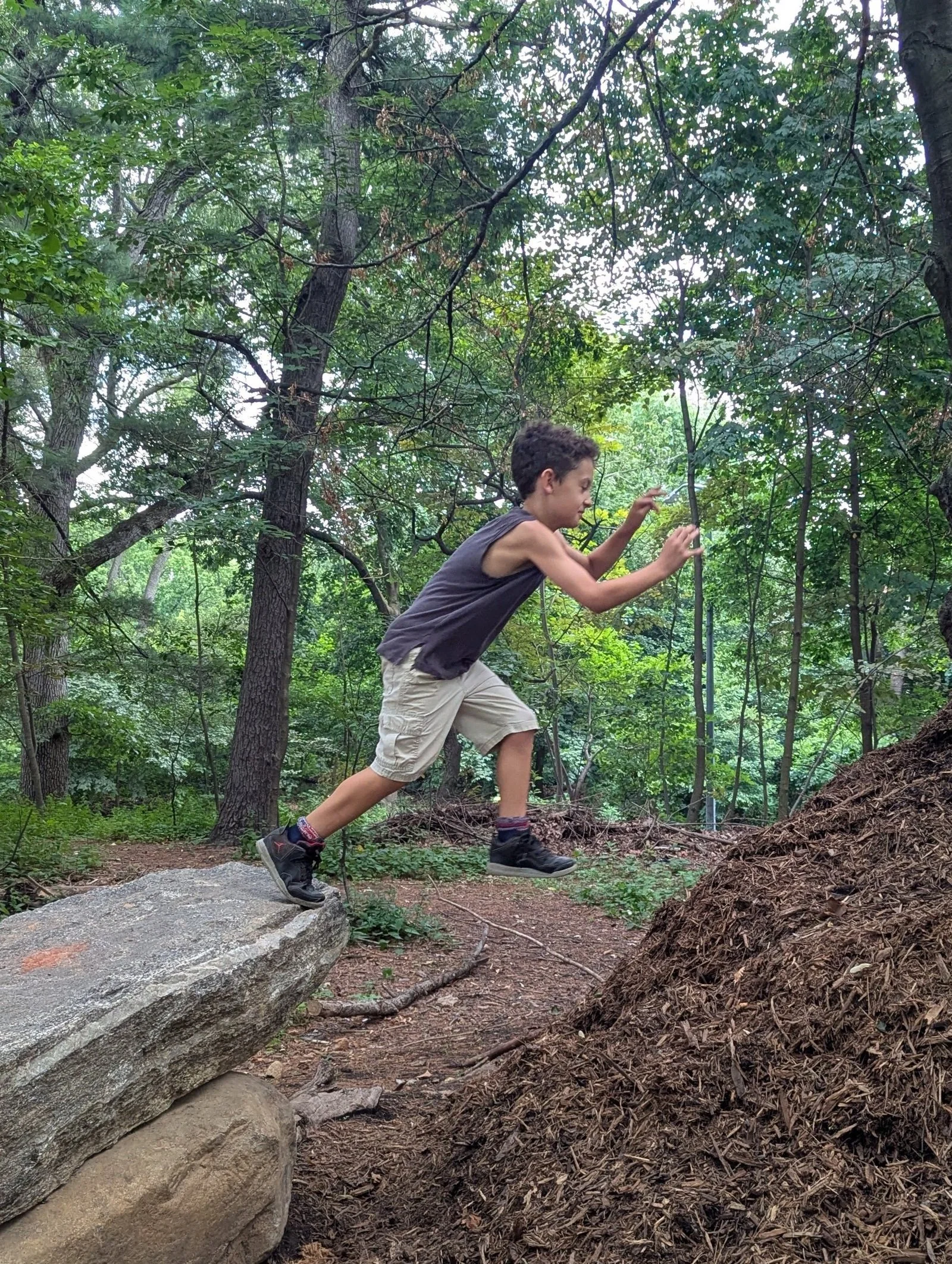 Wonder Kid jumping off rock in Prospect Park