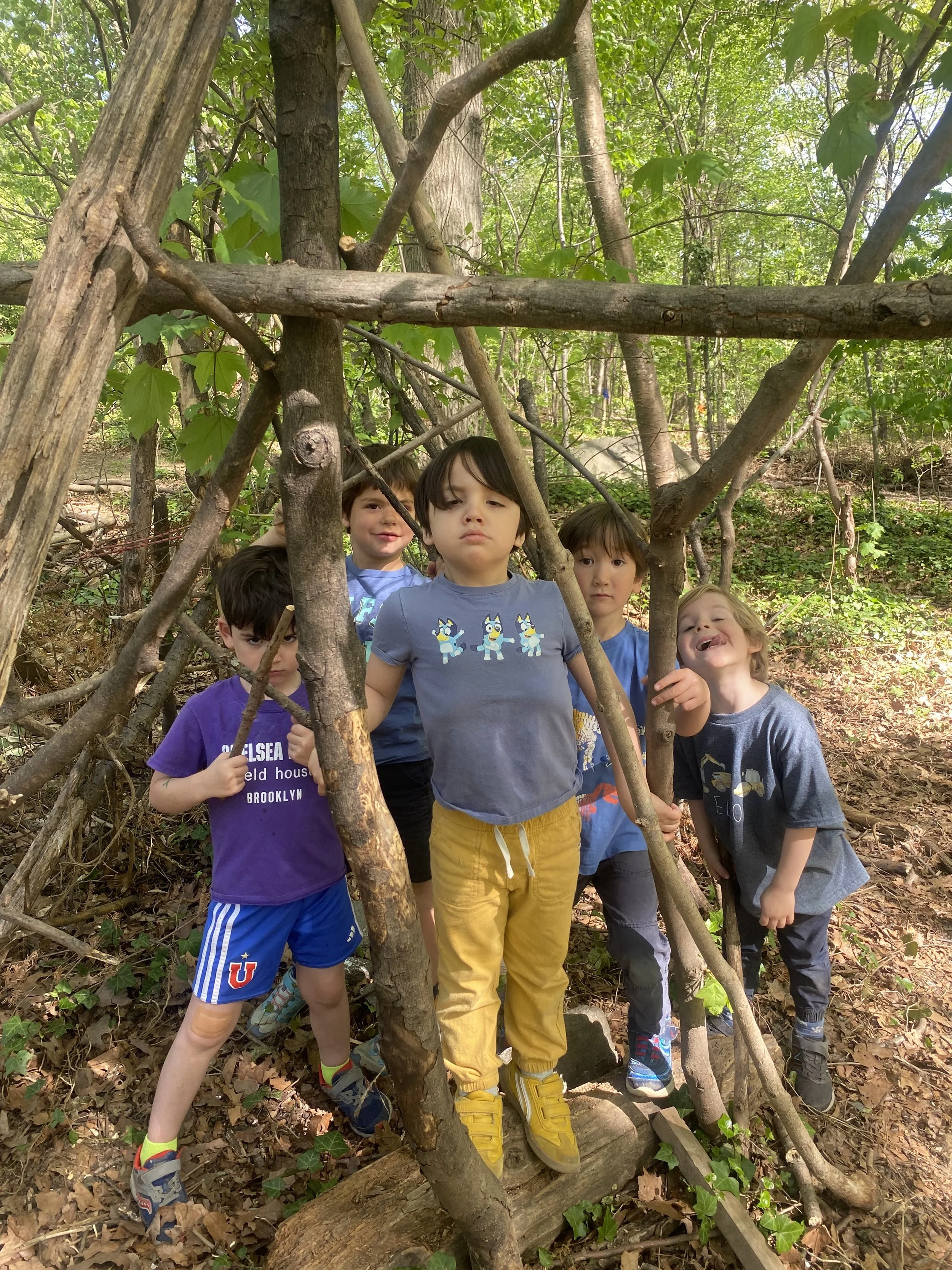 Wonder kids inside a stick fort they built during after school in Prospect Park