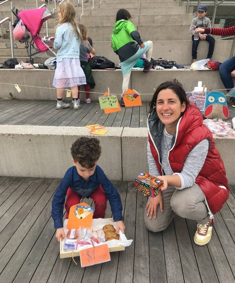 Teacher and kid with a vending stand