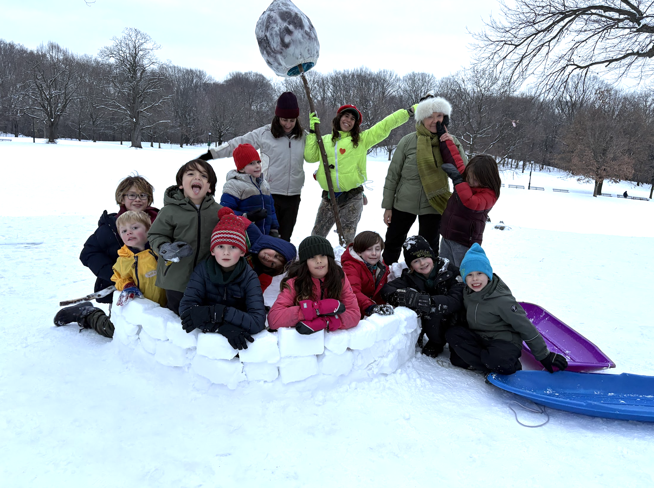 Wonder kids building a snow igloo during winter after school in Prospect Park