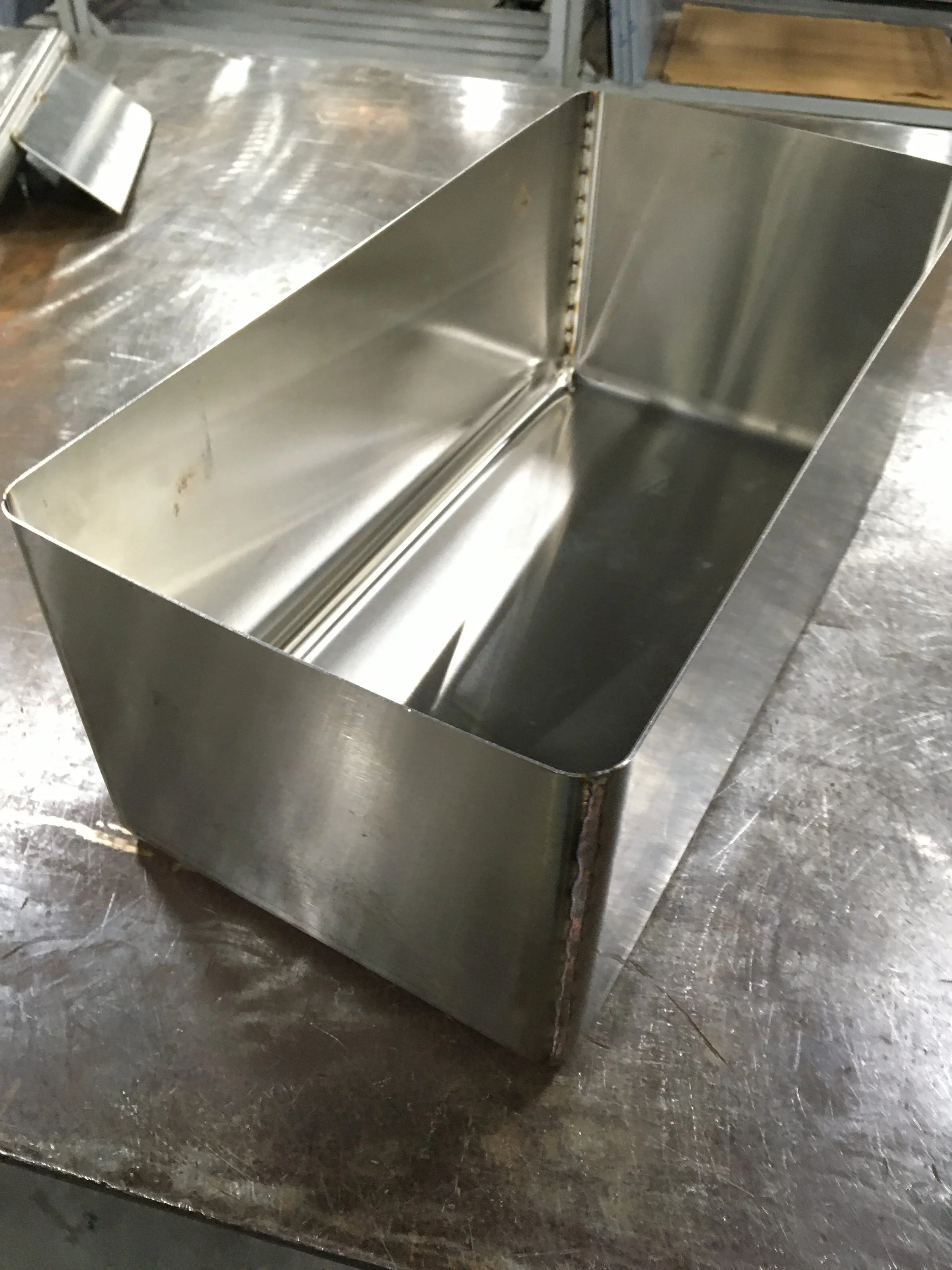 Rectangular stainless steel box on a metal table