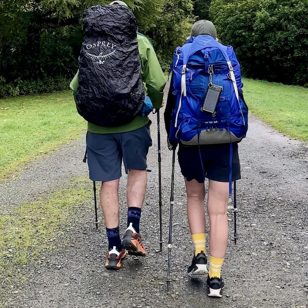 Two hikers with Merrell trail shoes and osprey backpacks hiking into the Tararua Mountains, New Zealand