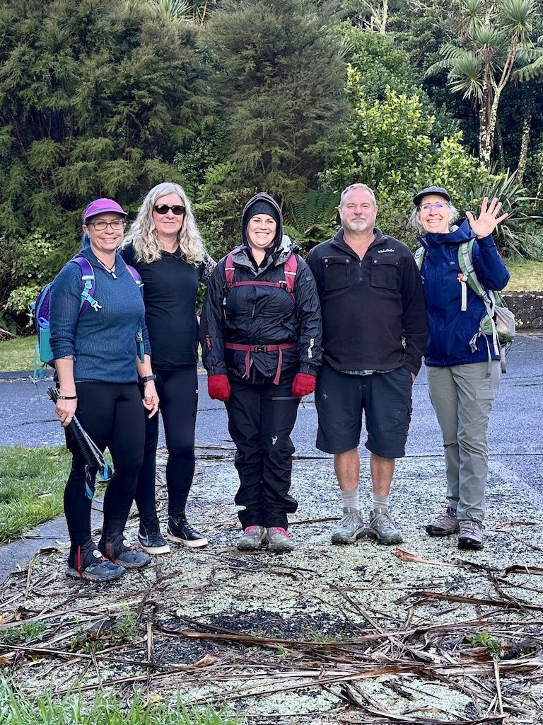 Smiling hikers at Lake Ōkataina