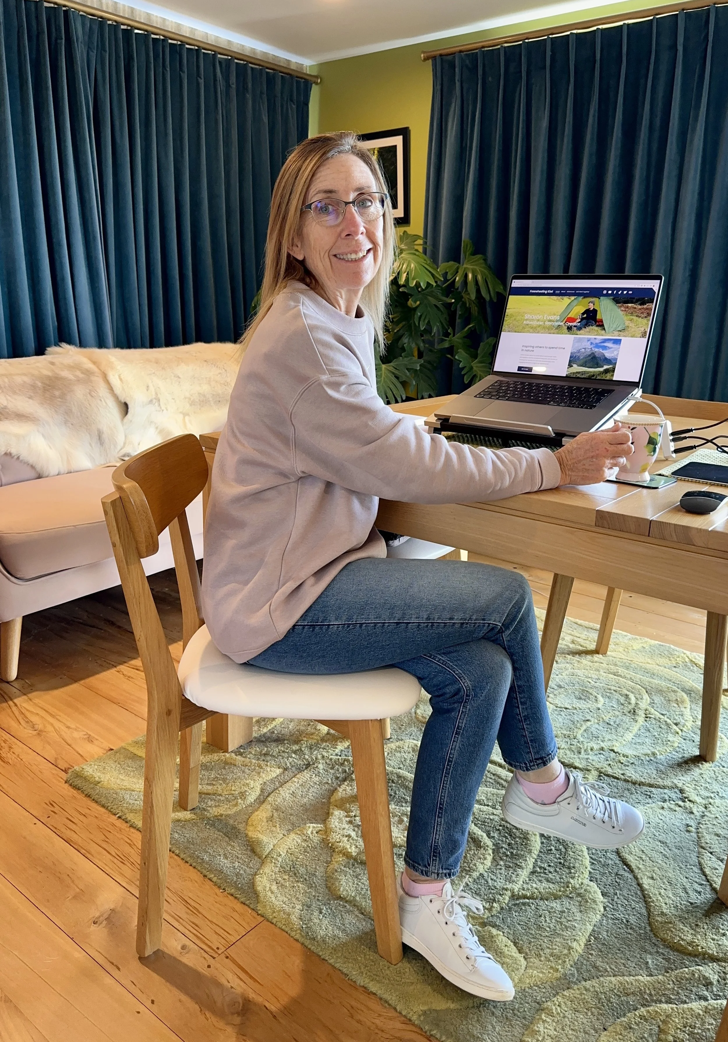 Smiling woman at desk with laptop