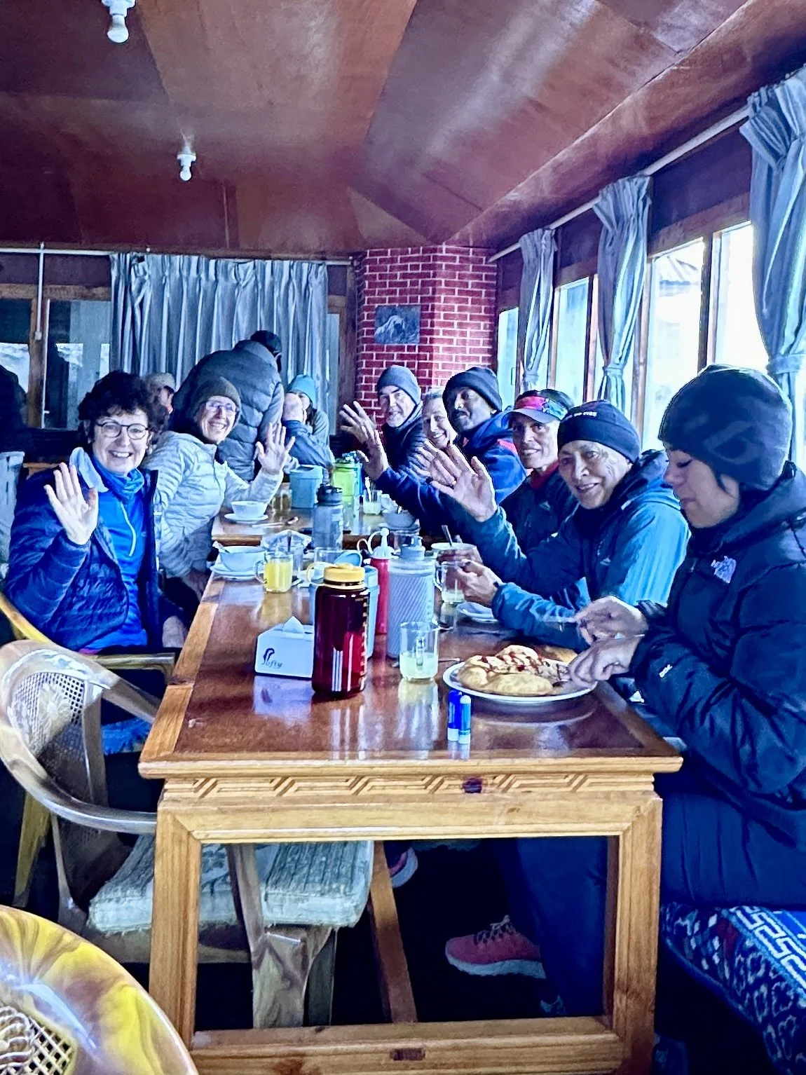 Smiling Everest Base Camp trekkers enjoying a teahouse breakfast