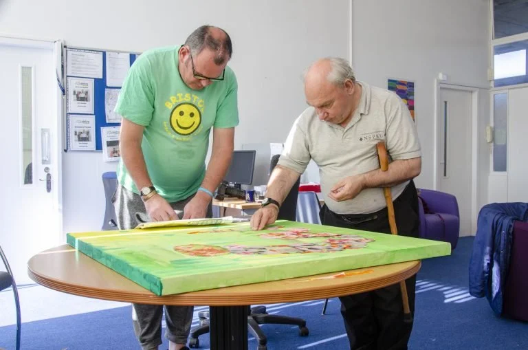 Image of Cintre people supported painting a picture.