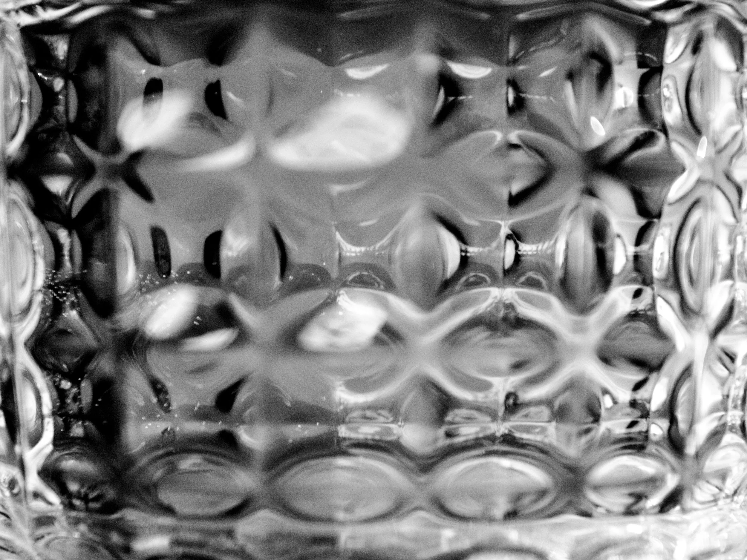 Close-up of a metallic surface with a textured, bubble-like pattern.