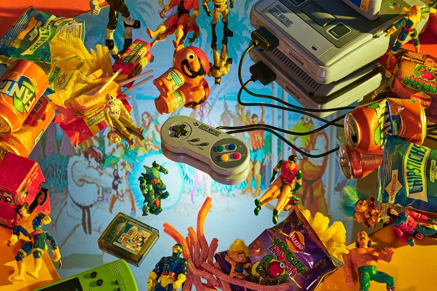 Retro Super Nintendo console with snacks, action figures, and a Game Boy, capturing 90s gaming nostalgia in a flat lay.