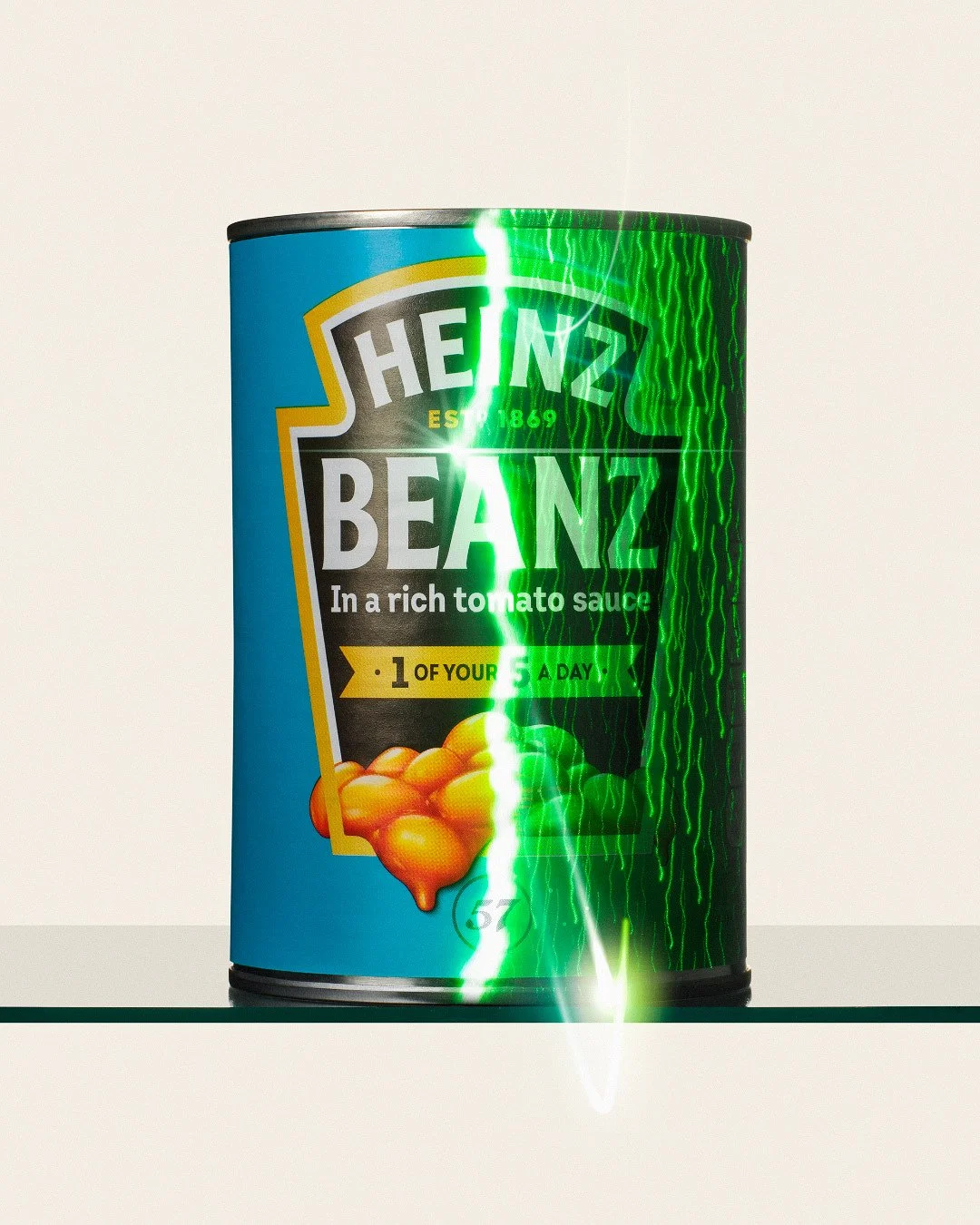 Heinz Beanz can on a reflective surface with a bright green energy glow effect splitting the label.