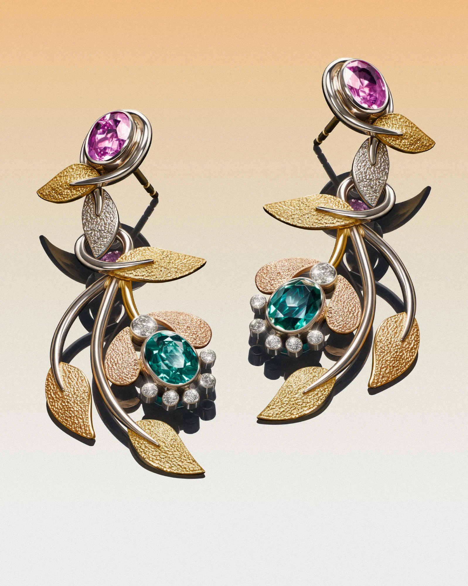 Elegant floral drop earrings with pink sapphires, green tourmalines, and diamonds in mixed-metal gold and silver settings.