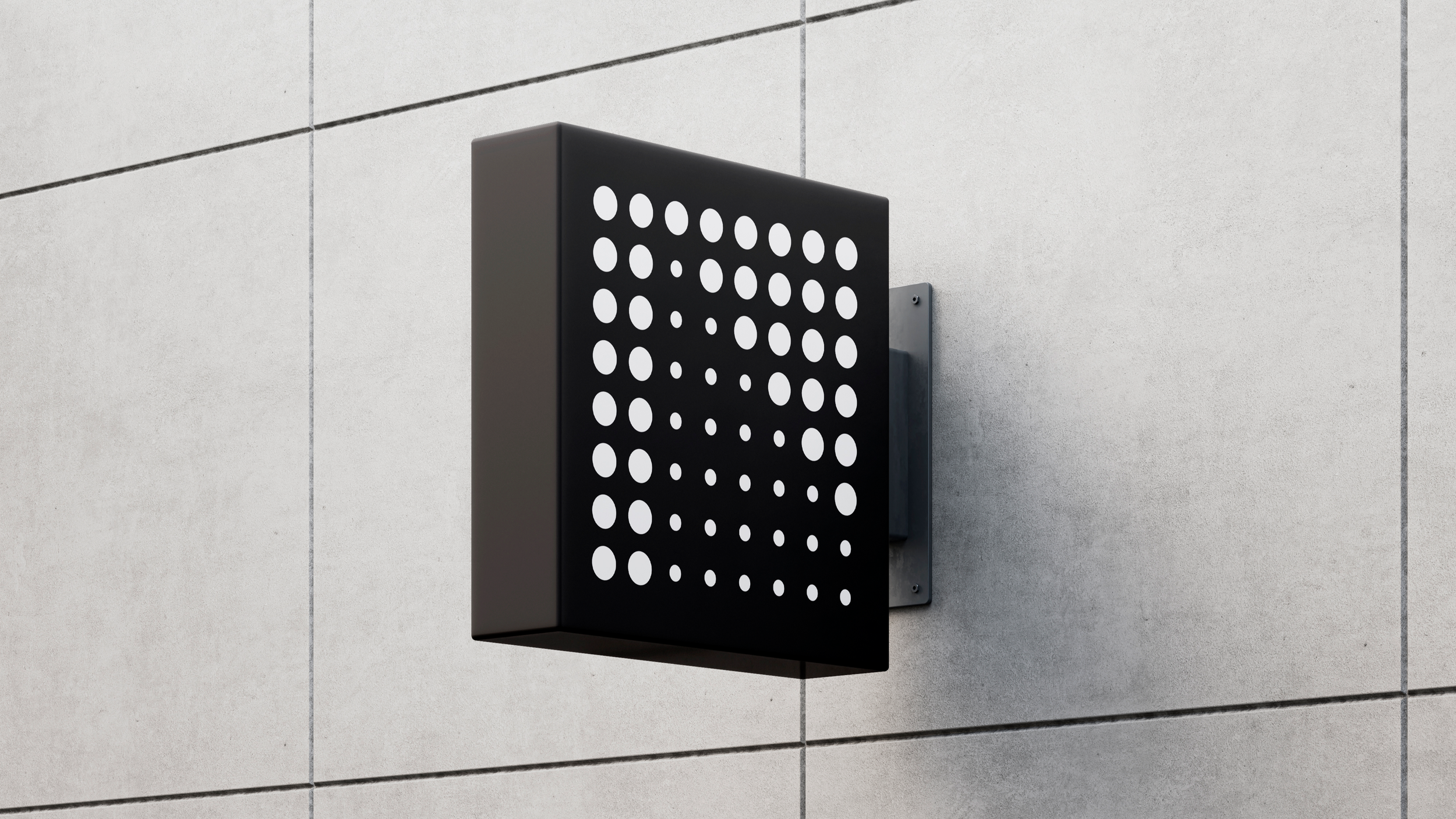 Close-up of a black outdoor wall-mounted light fixture with a perforated metal cover, attached to a light-colored tiled wall.