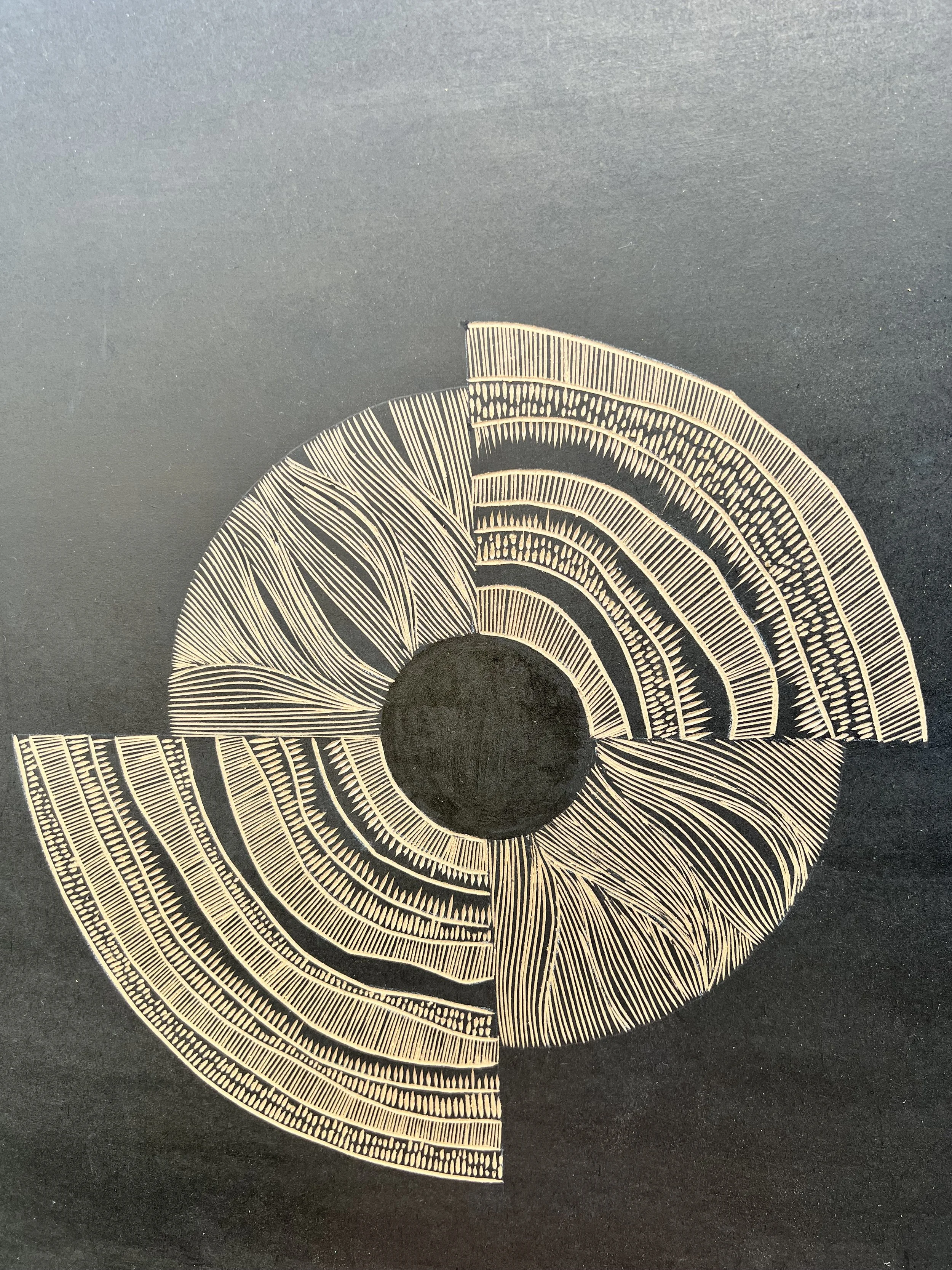 Abstract geometric pattern with concentric circles and intricate line designs on a dark background.