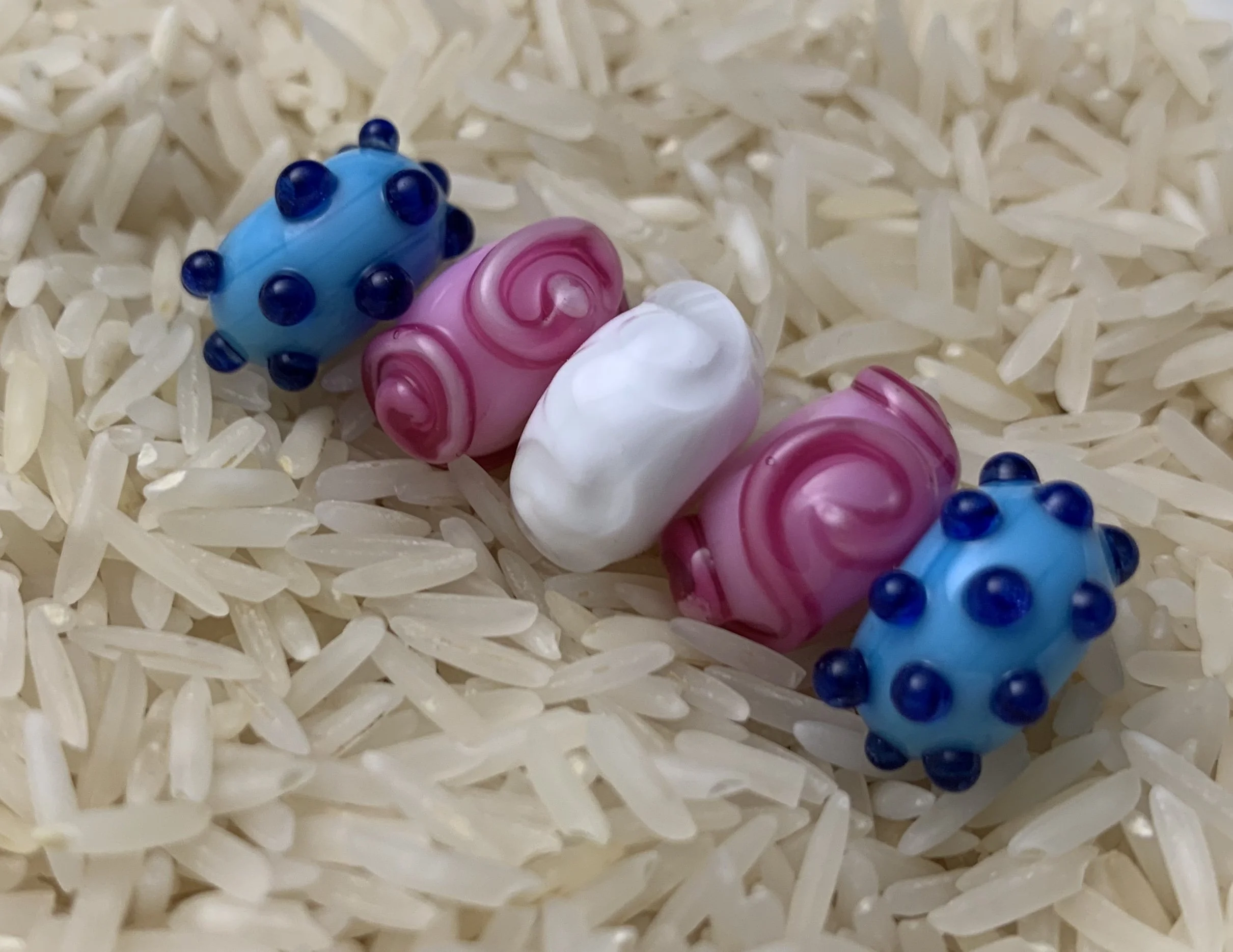 blue, pink, and white beads with different textures