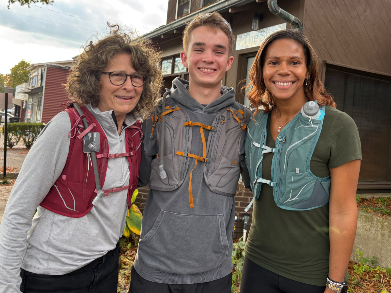 three people wearing Osprey trail running vests