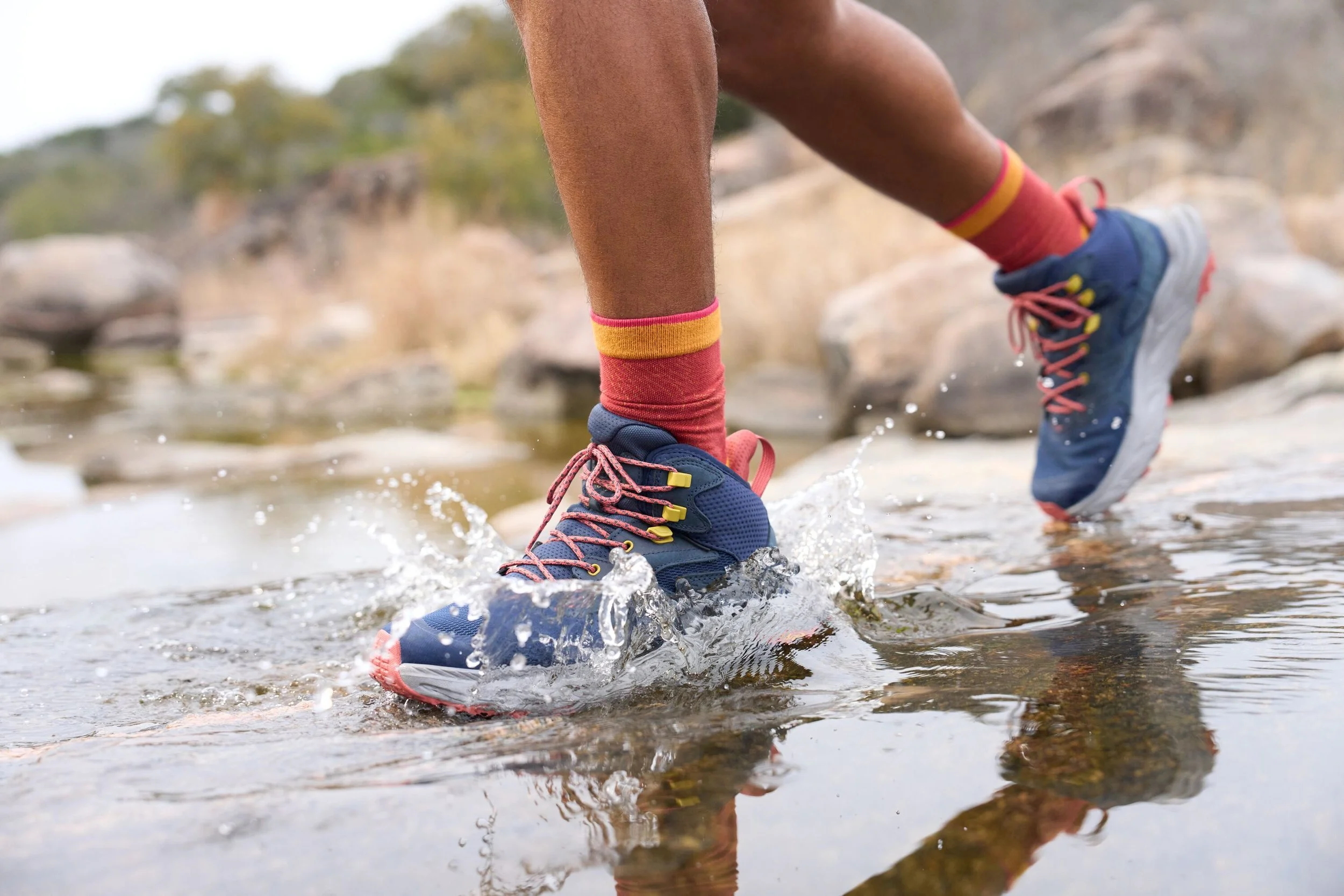 Person running in HOKA shoes in water
