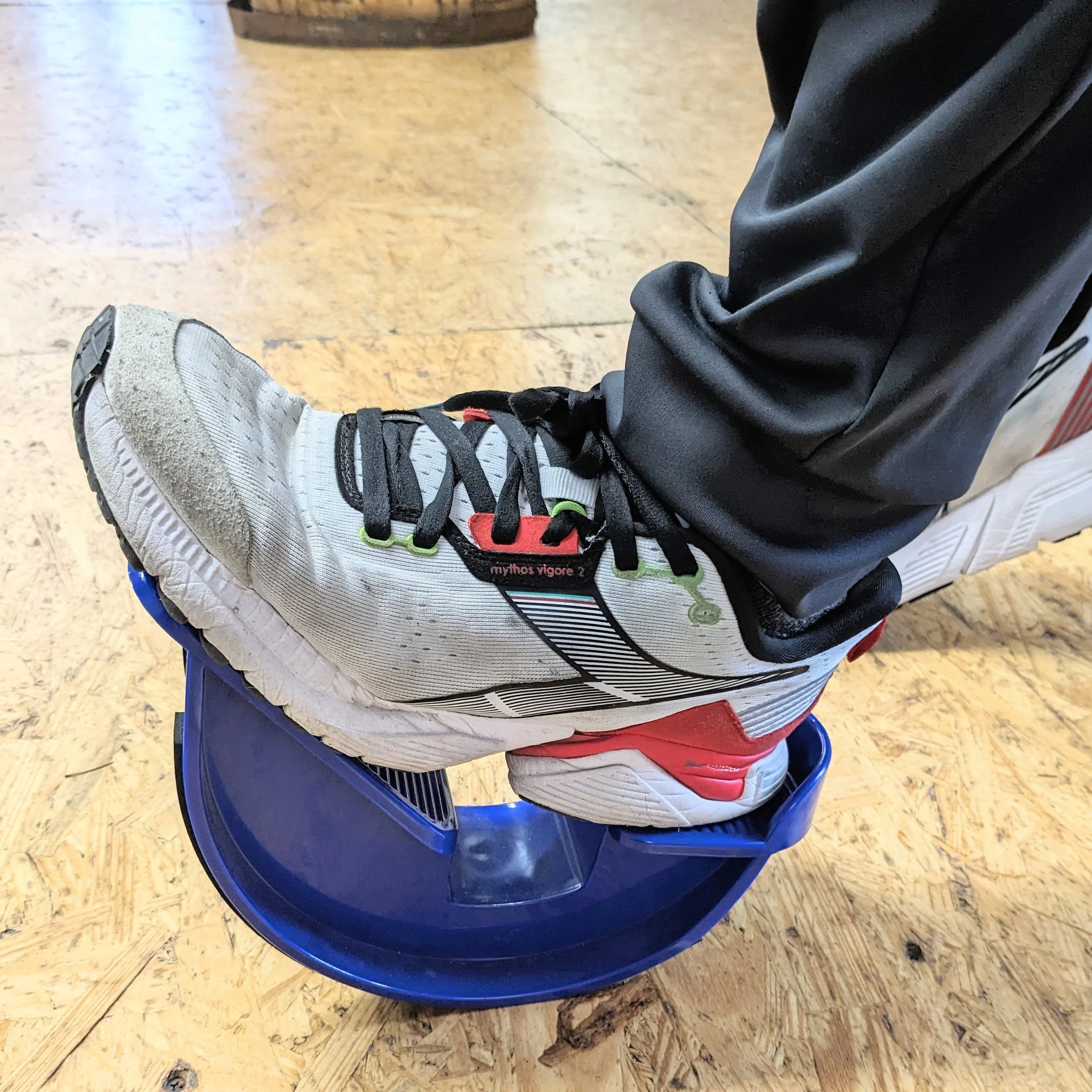 Person in Diadora running shoes using a PowerStep’s UltraFlexx® Foot Rocker