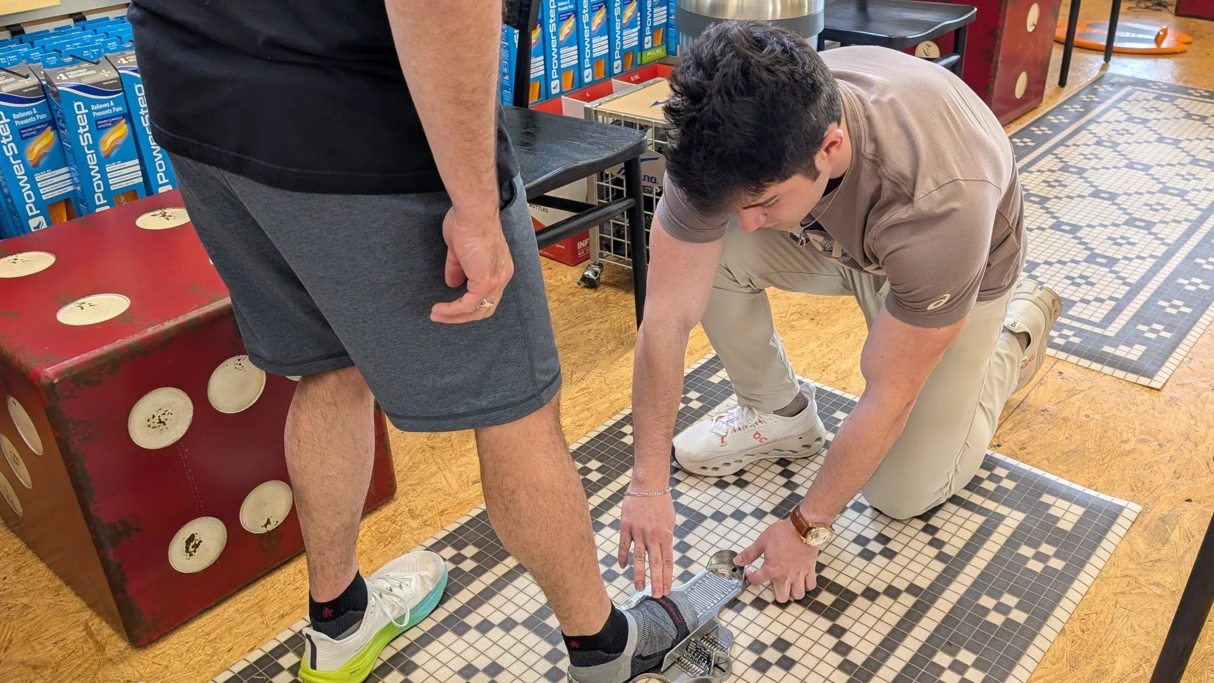 John's Run/Walk Shop employee measuring a customer's feet