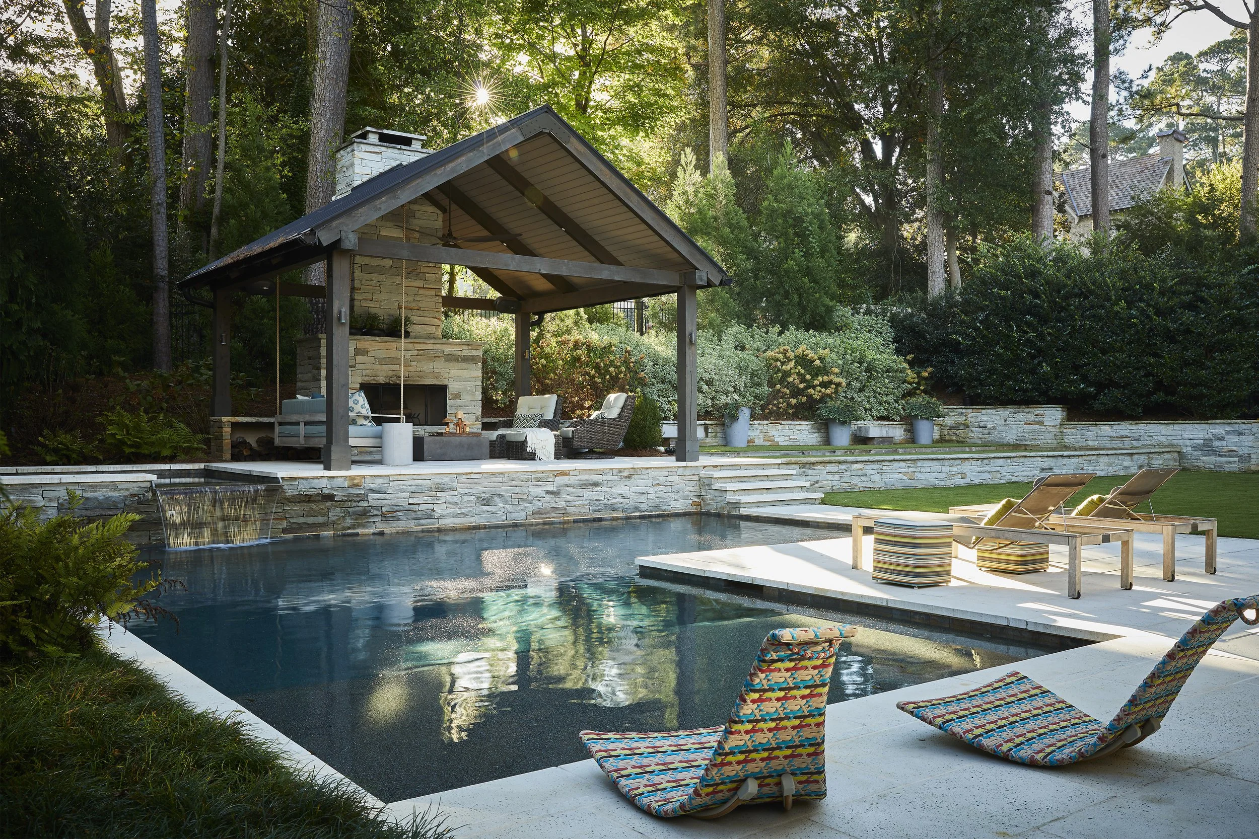 Poolside view with outdoor fireplace sitting area.