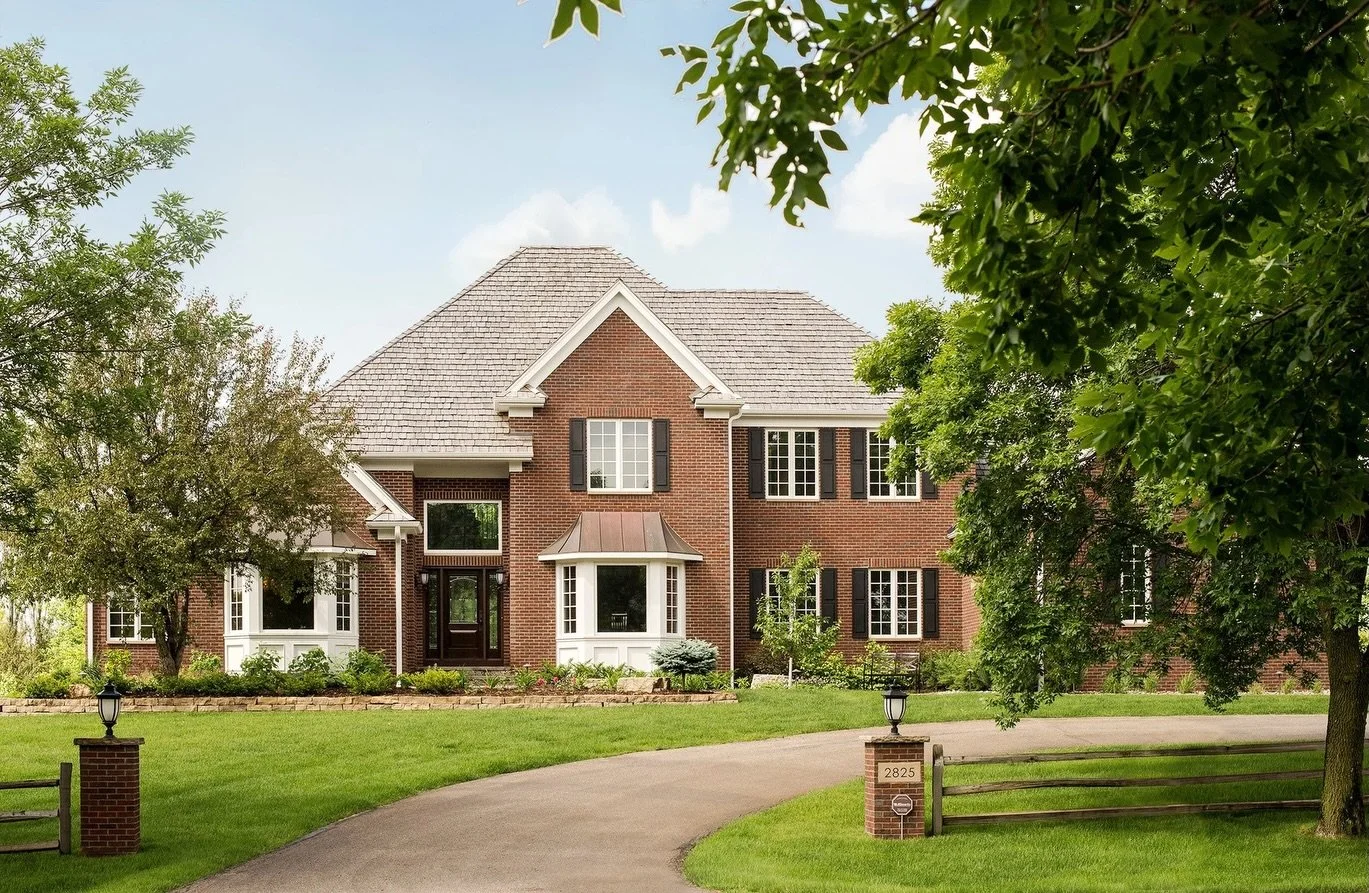 Our client was looking for a more elevated, stately exterior to enhance their home&rsquo;s presence. To achieve that timeless look, we replaced the existing stucco with rich brick and added a brick ledge along three sides of the foundation&mdash;brin