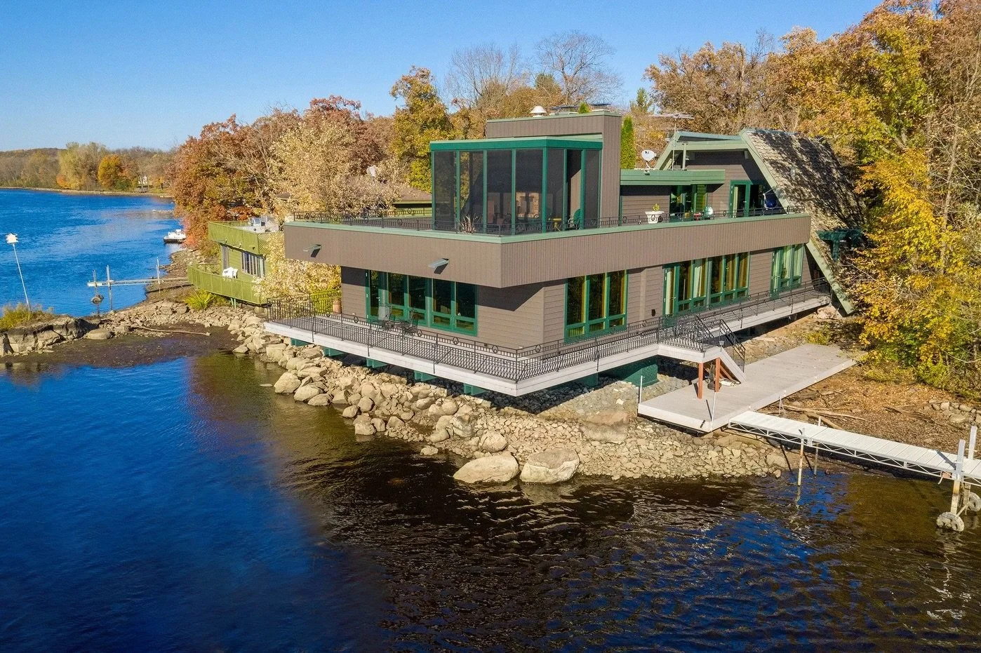 When the view is this breathtaking, the home has to live up to it. 
For this riverfront project, we completed a full exterior remodel. We replaced all the windows and siding and rebuilt the roof over the screen porch.

One of our biggest challenges w
