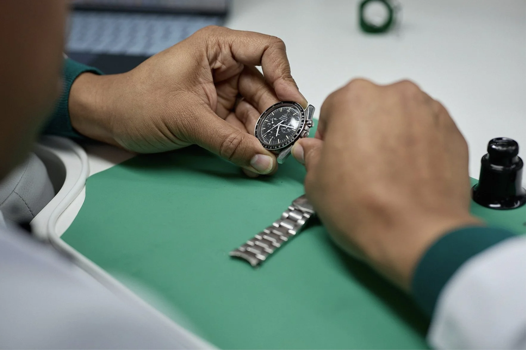 Chrono24 Certified watchmaker servicing Omega watch during authentication process at The Watch Barn