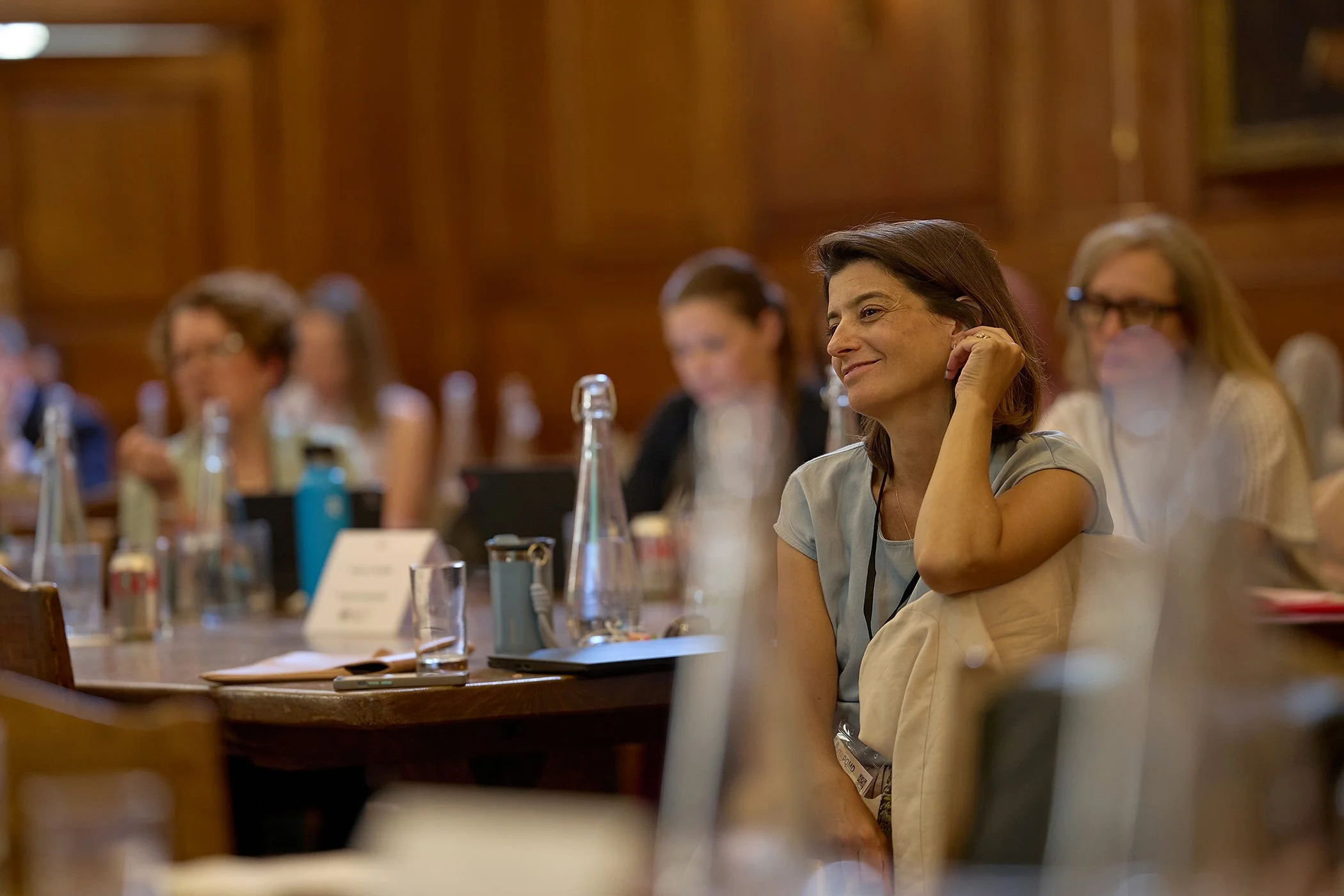 Unobtrusive event photography of a business delegate engaged in a high-level IHP session at Goodenough College, capturing the human element of a London health summit.