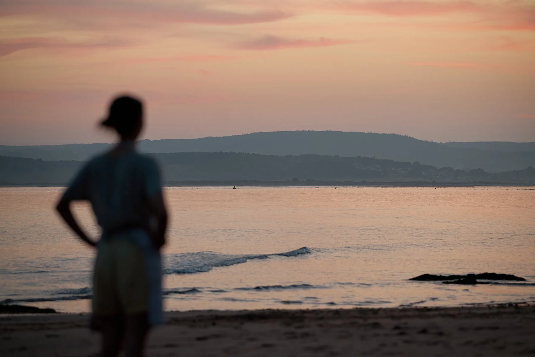 Authentic brand storytelling shot of Hannah Thomas, founder of Herbs & Wild, preparing fresh coastal ingredients in Sidmouth, Devon, for food editorial and culinary PR.