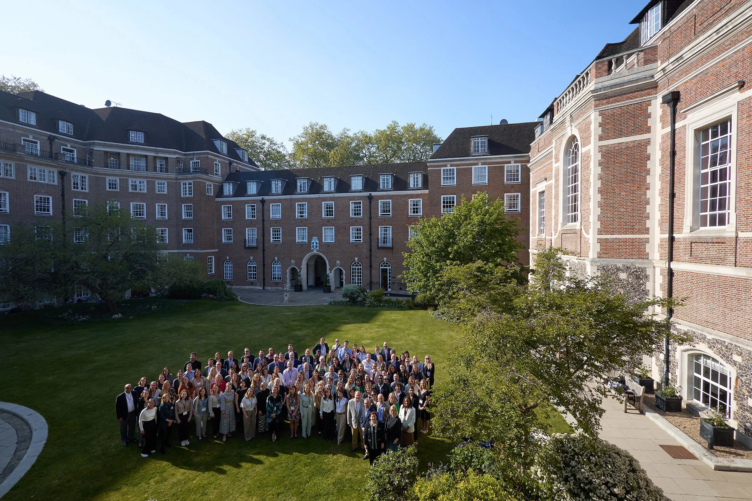 Official IHP group shot of speakers and attendees at the Global Health Forum, captured on the grounds of Goodenough College, London, for annual review and PR assets.