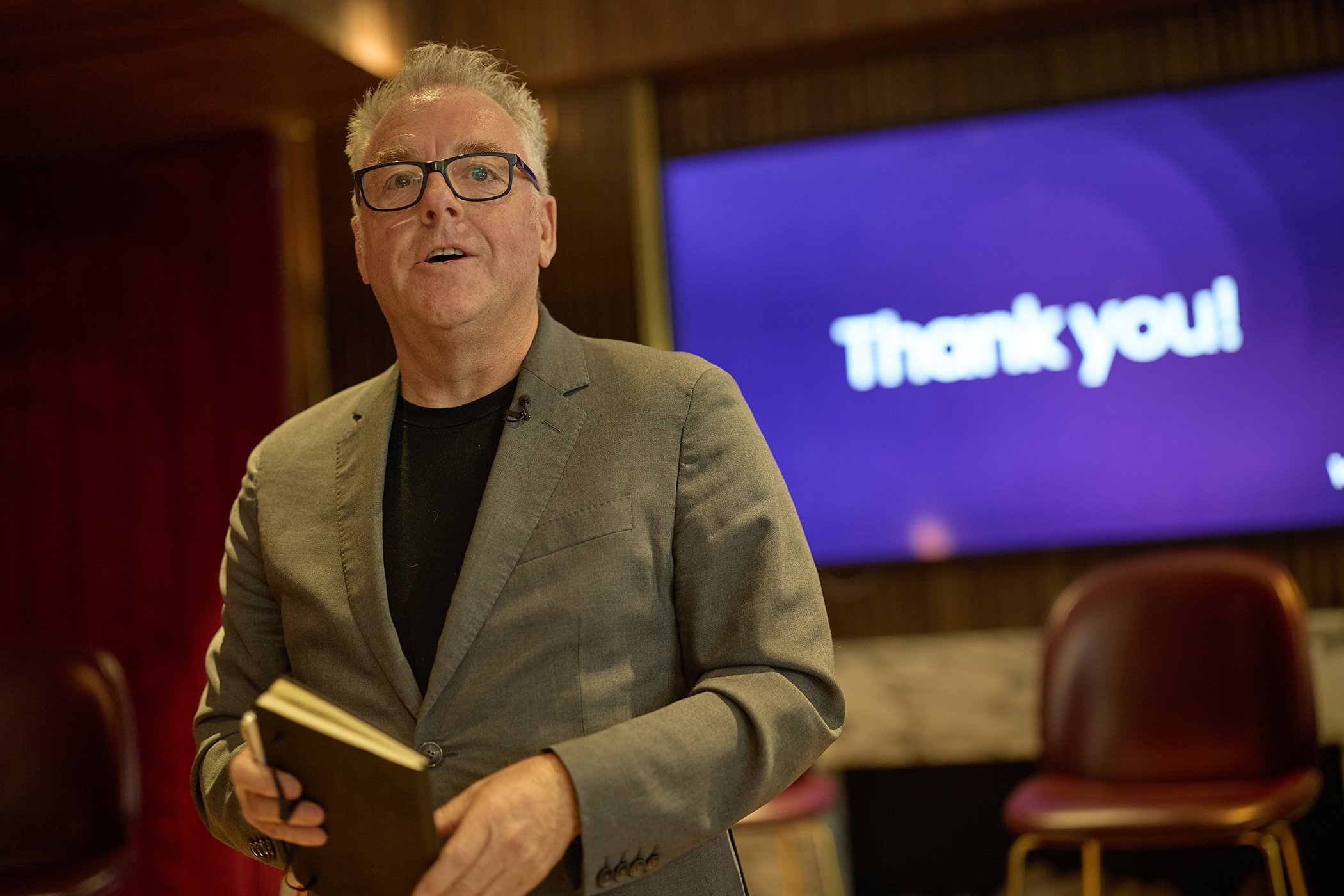 andid event photography of Martin Smethurst, CCO of VoCoVo, presenting new voice-led retail communication solutions at a London tech summit.