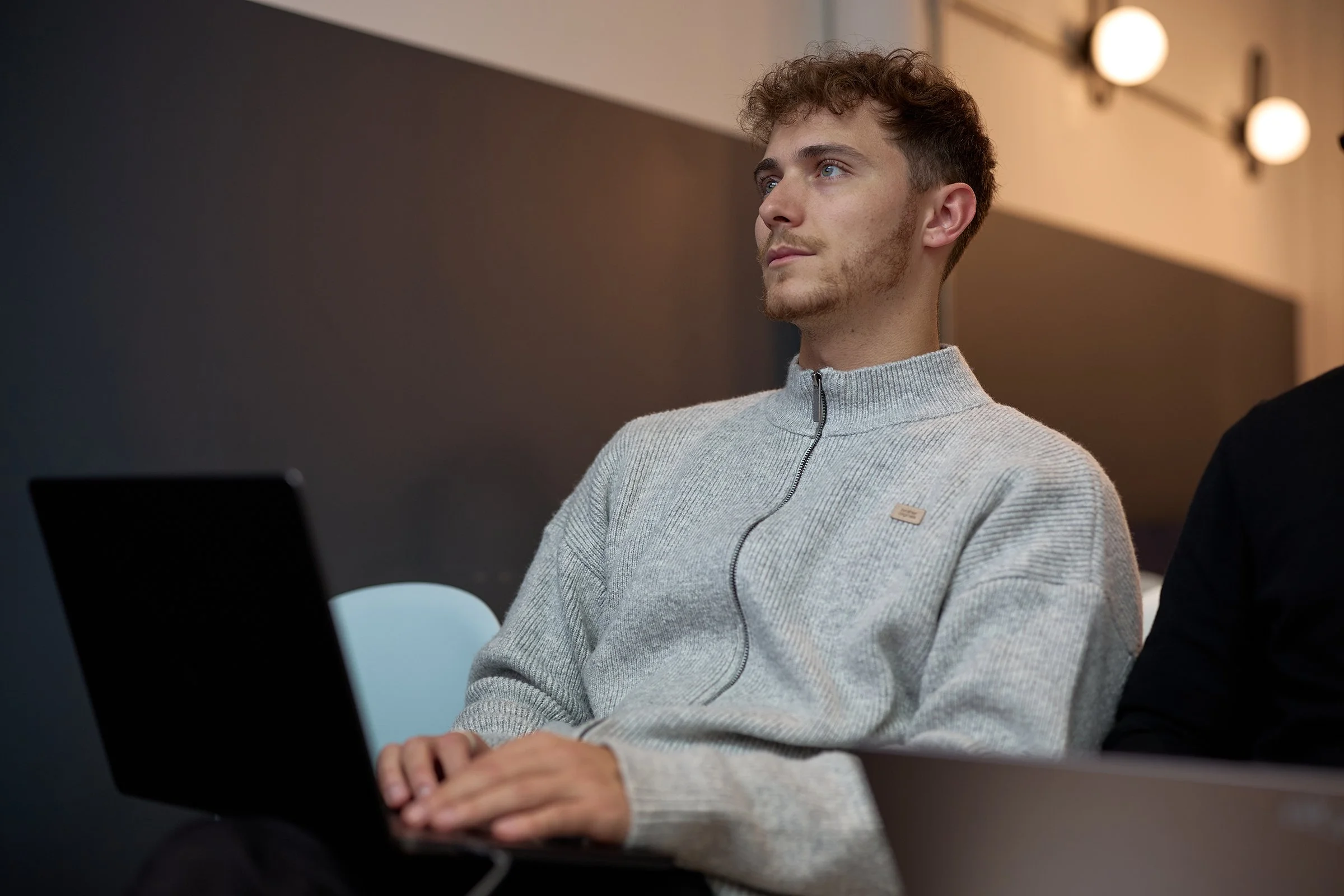 Candid photography of Josh King, Technical Co-founder and CTO of &above, engaged in a high-level AI tech discussion at a London corporate event.