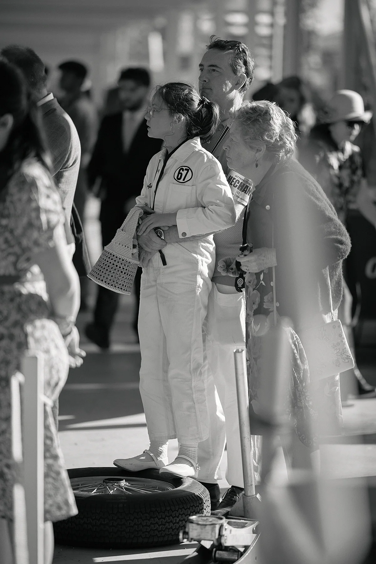 Daughter standing on a Dunlop racing tyre with her father in the pit lane at Goodwood Revival 2026