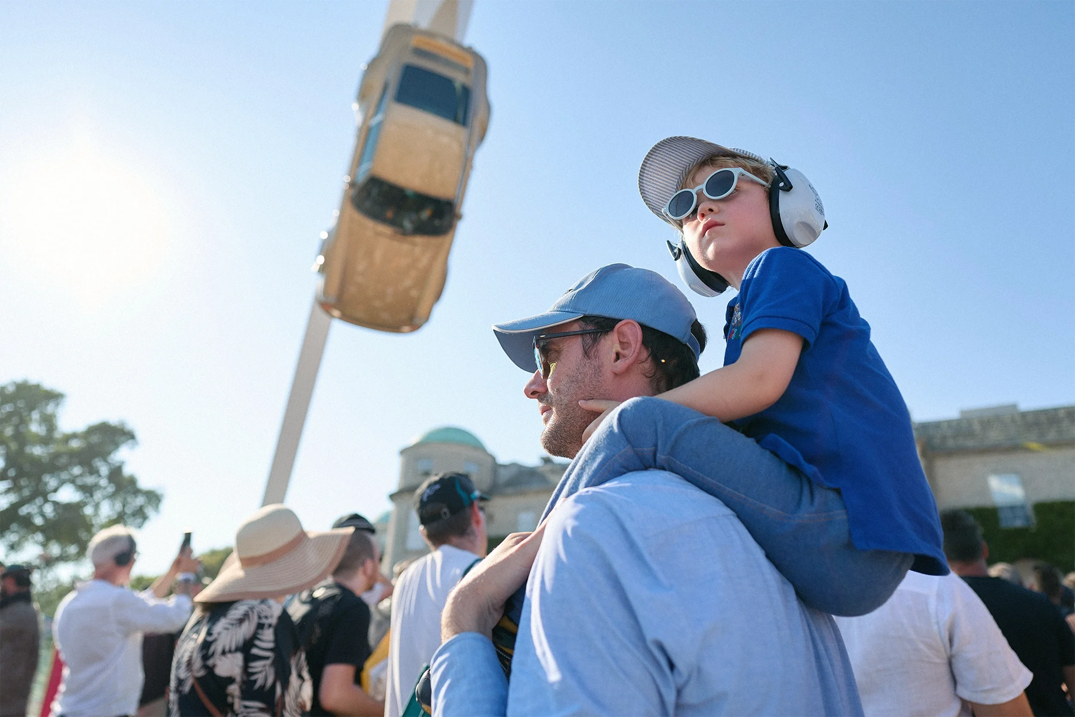 Father carrying his son on his shoulders while watching the Central Feature at the 2026 Goodwood Festival of Speed.