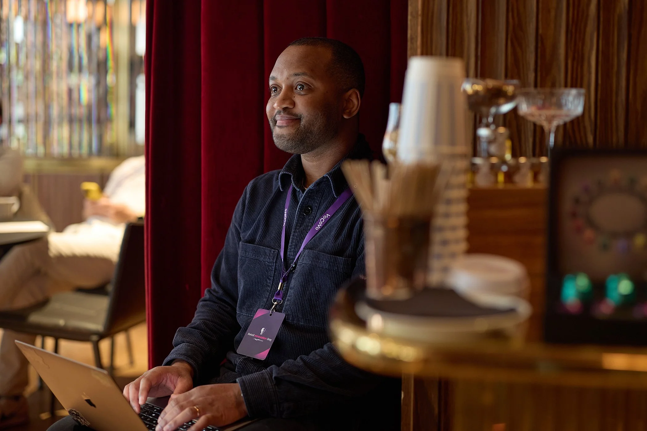 Detail shot of a delegate taking notes during a VoCoVo corporate event in London, capturing the human engagement and focus of a high-level business session.