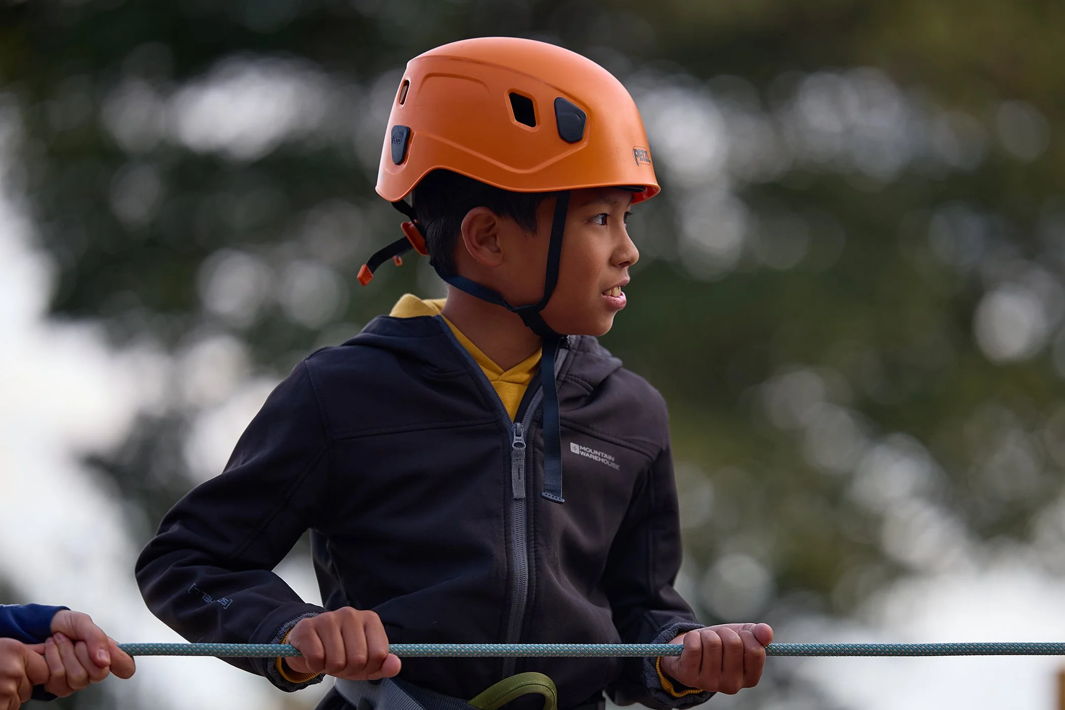 Action portrait photography of a young boy on a climbing wall at the Cobham Activities Centre to promote new sports facilities and youth engagement.