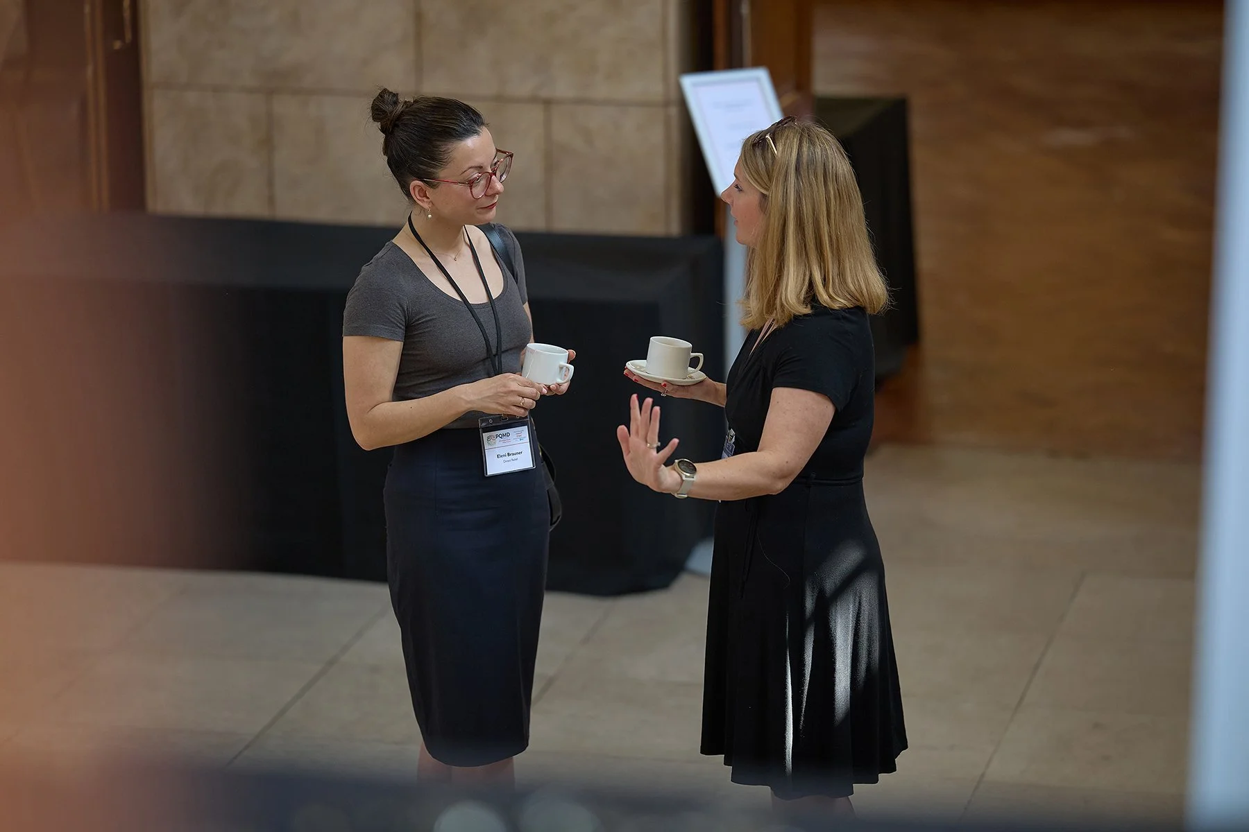 Official **business** group portrait of IHP speakers and delegates at a London **corporate** summit, captured on the grounds of Goodenough College.