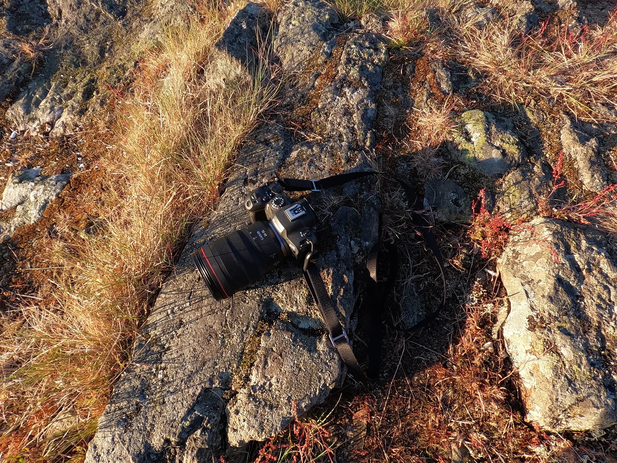 Behind-the-scenes kit shot of a Canon R6 Mark II camera paired with a Canon RF 24-70mm lens during a travel photography shoot in Sweden.
