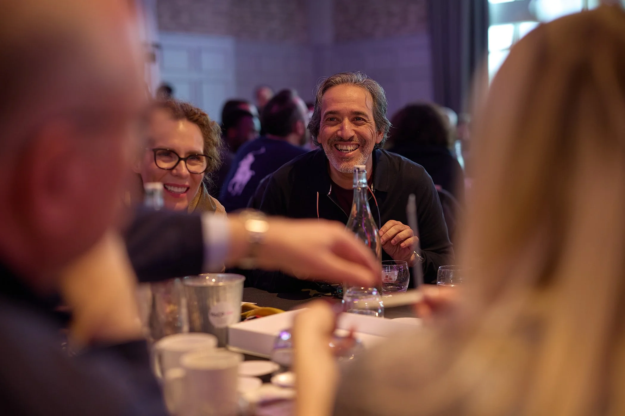 A candid social interaction between attendees during a break at the VoCoVo corporate summit in Oxford.