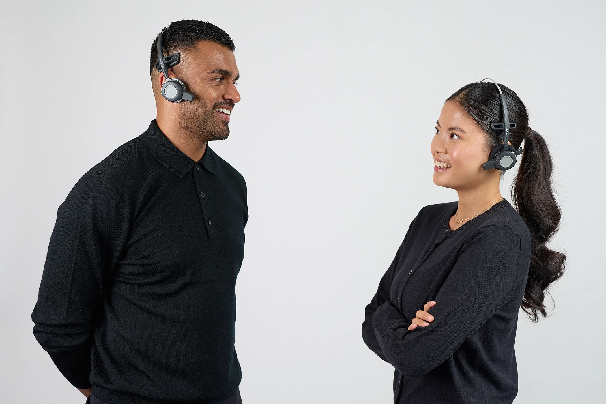 Professional studio image of two models showcasing VoCoVo communication headsets.